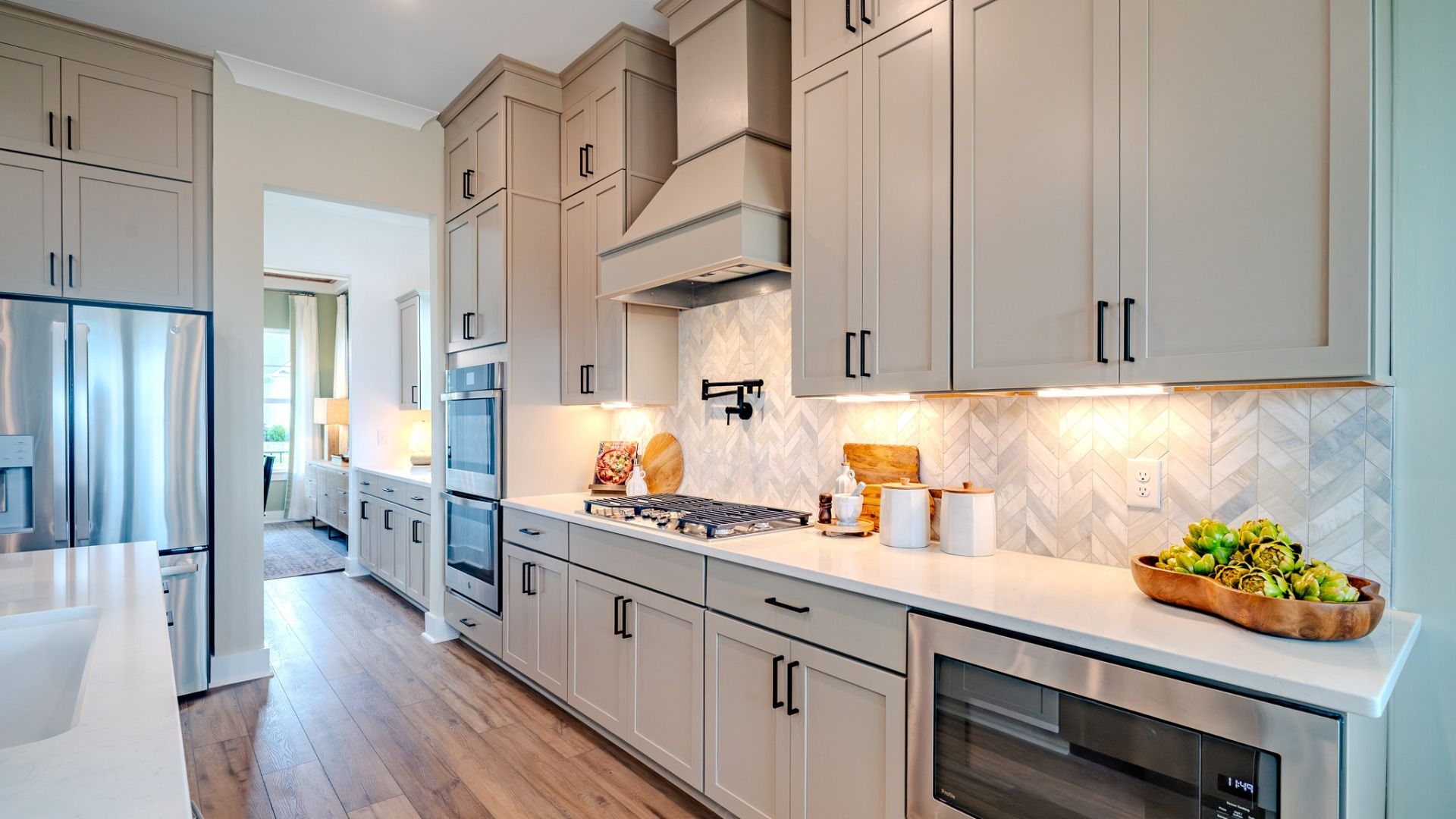 Kitchen with tile backsplash, quartz countertops, and stainless-steel appliances