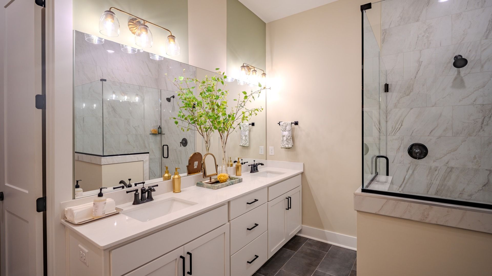 Primary bathroom with dual vanity and glass enclosed shower