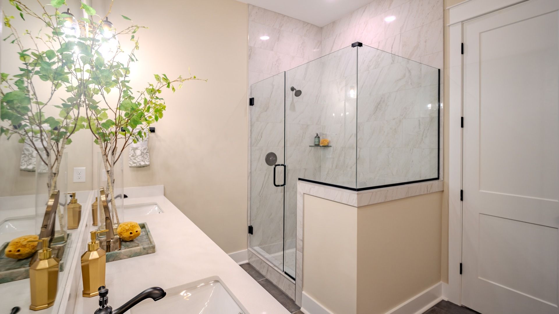 Primary bathroom with dual vanity and glass enclosed shower