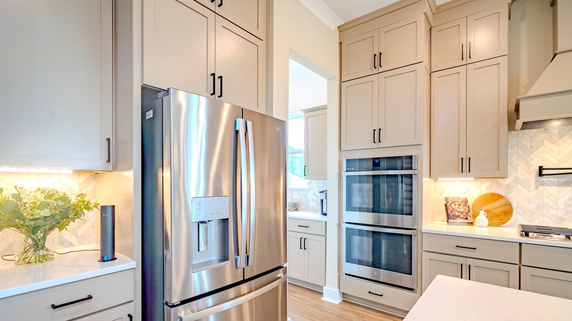 Kitchen with tile backsplash, quartz countertops, and stainless-steel appliances