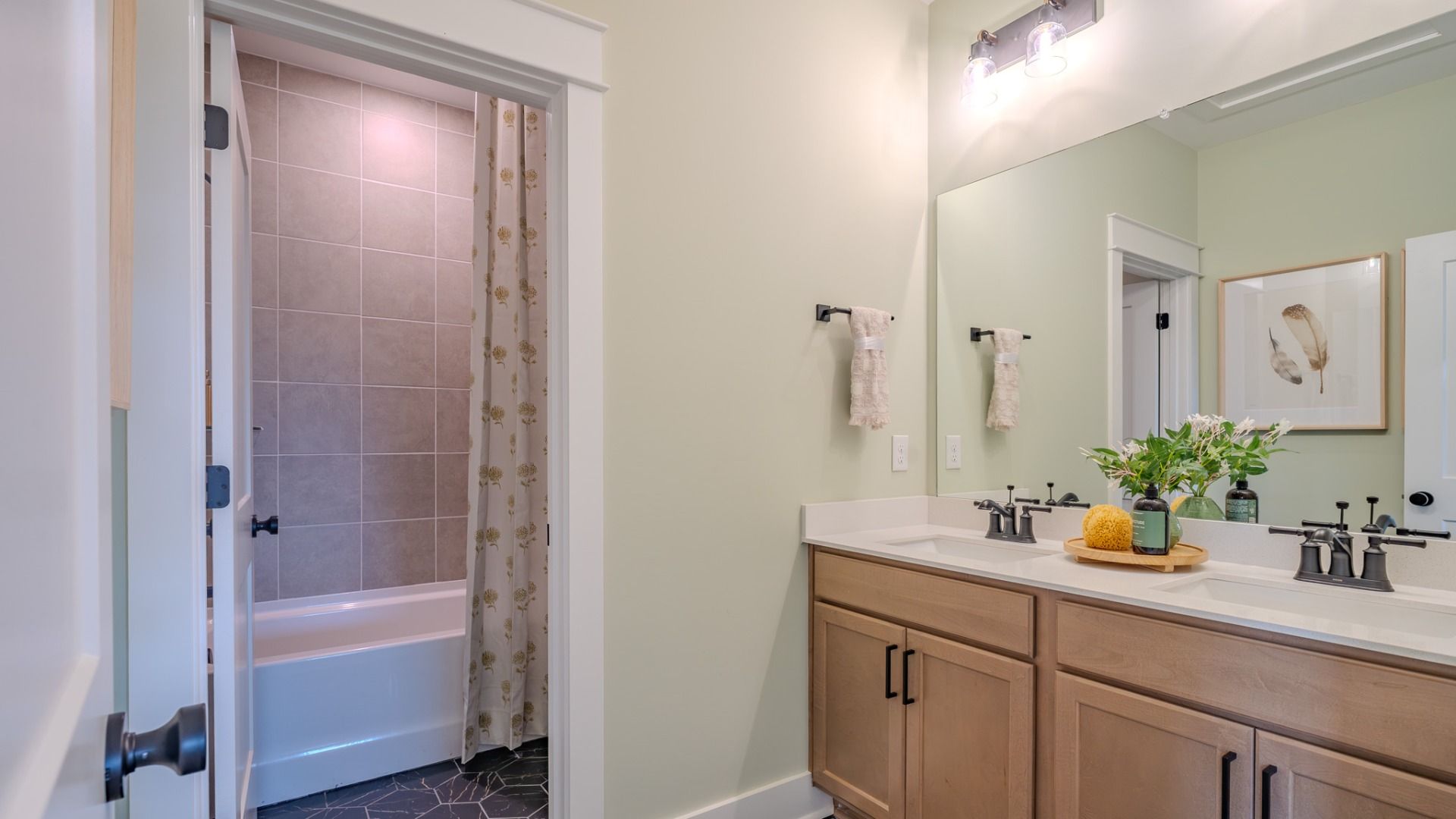Spacious secondary bathroom with dual vanity and separate shower area