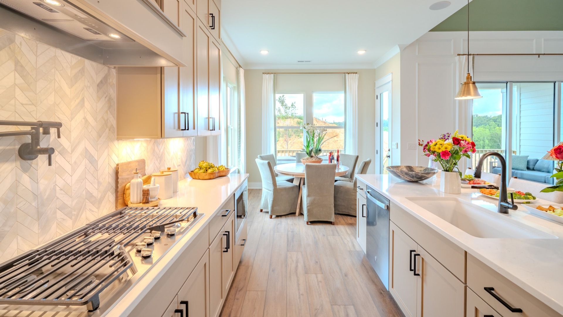 Kitchen with tile backsplash, quartz countertops, and pendant lighting