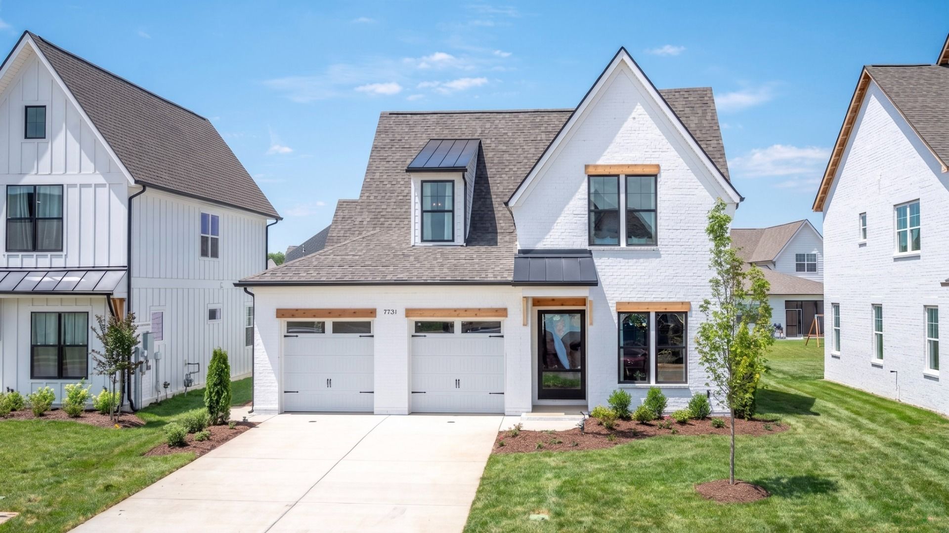 Front exterior with white siding and 2-car garage