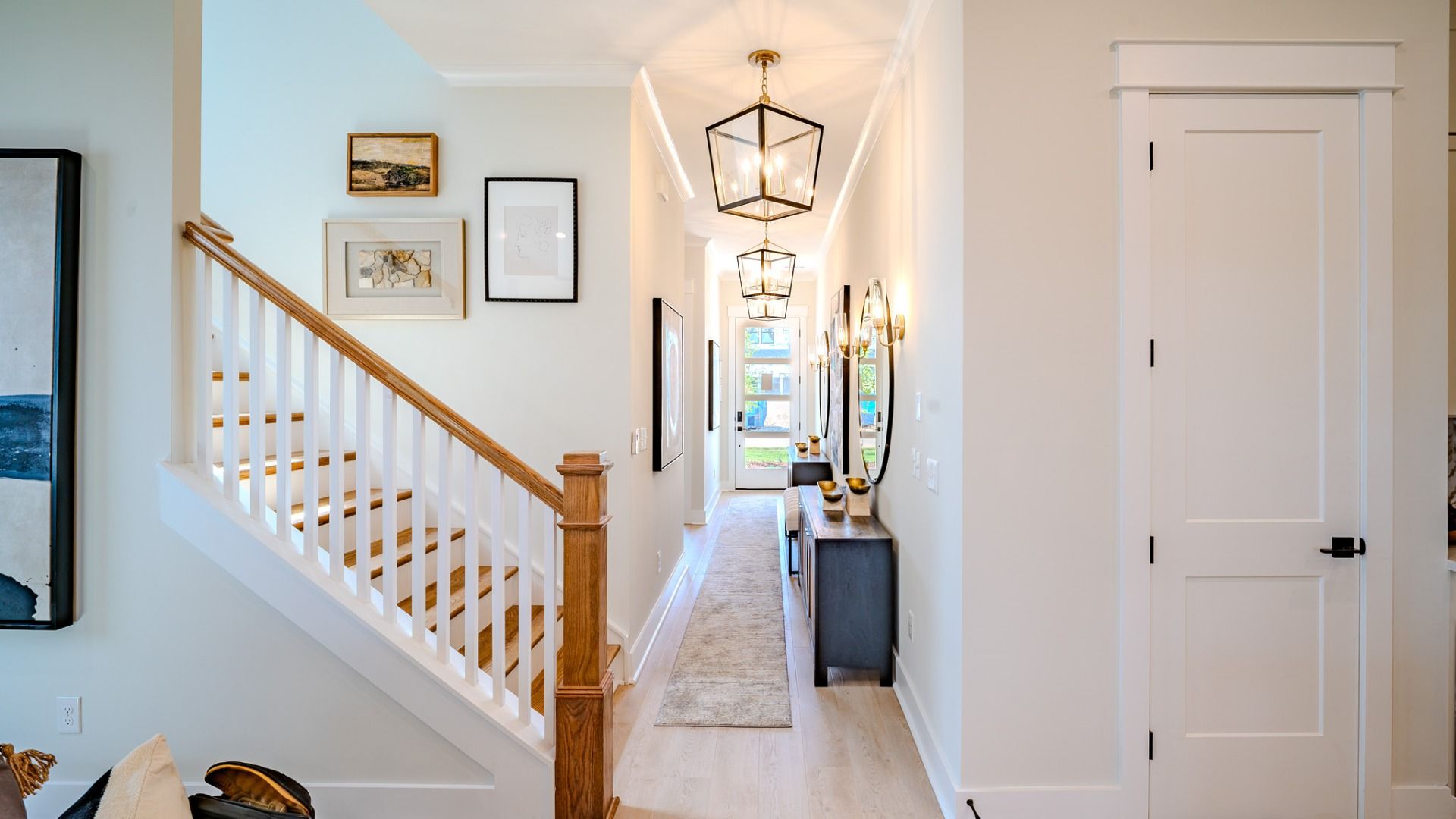 Front Entryway of home with long hallway and pendant lighting