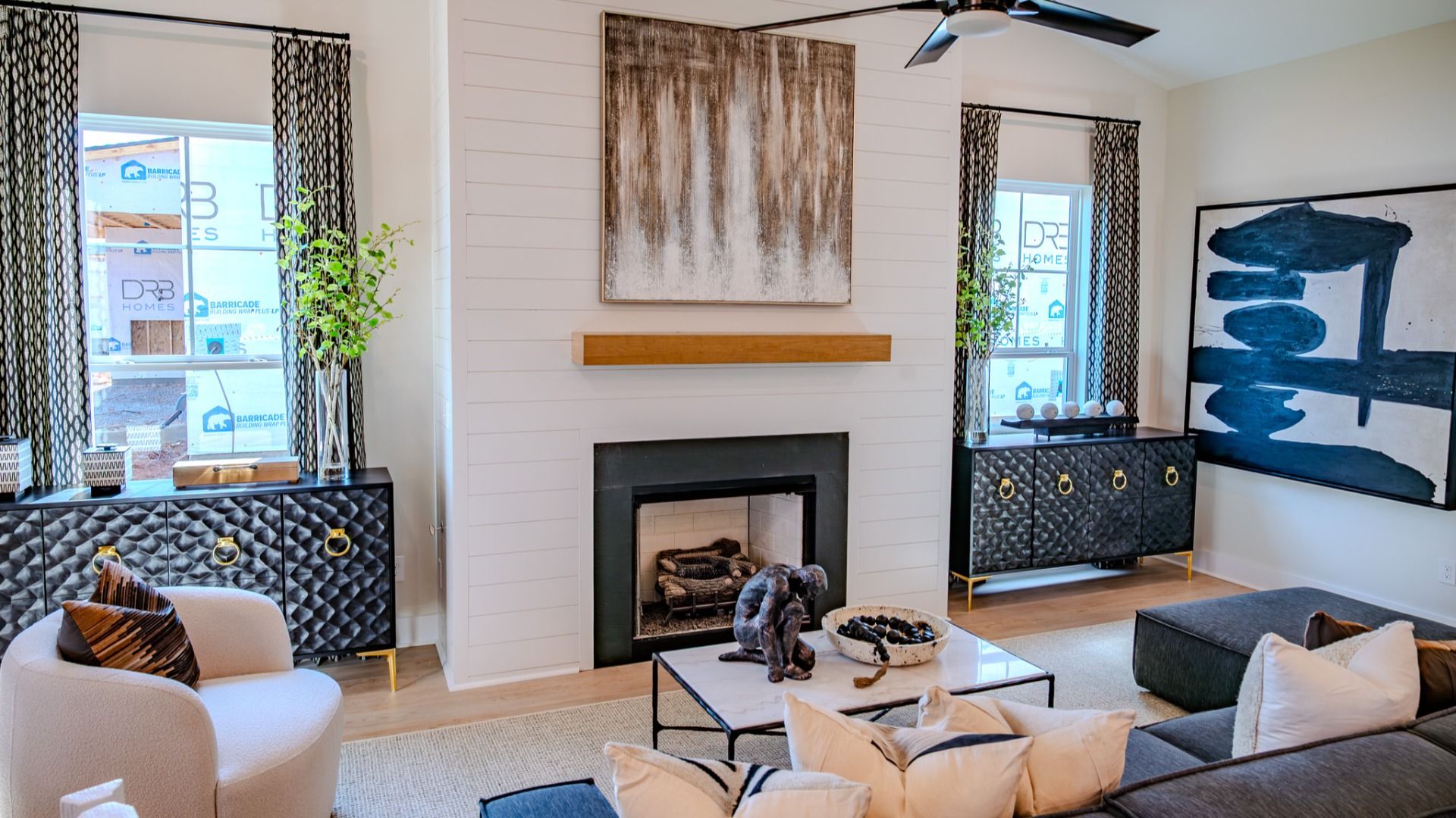 Gathering room with fireplace, ceiling fan, large windows