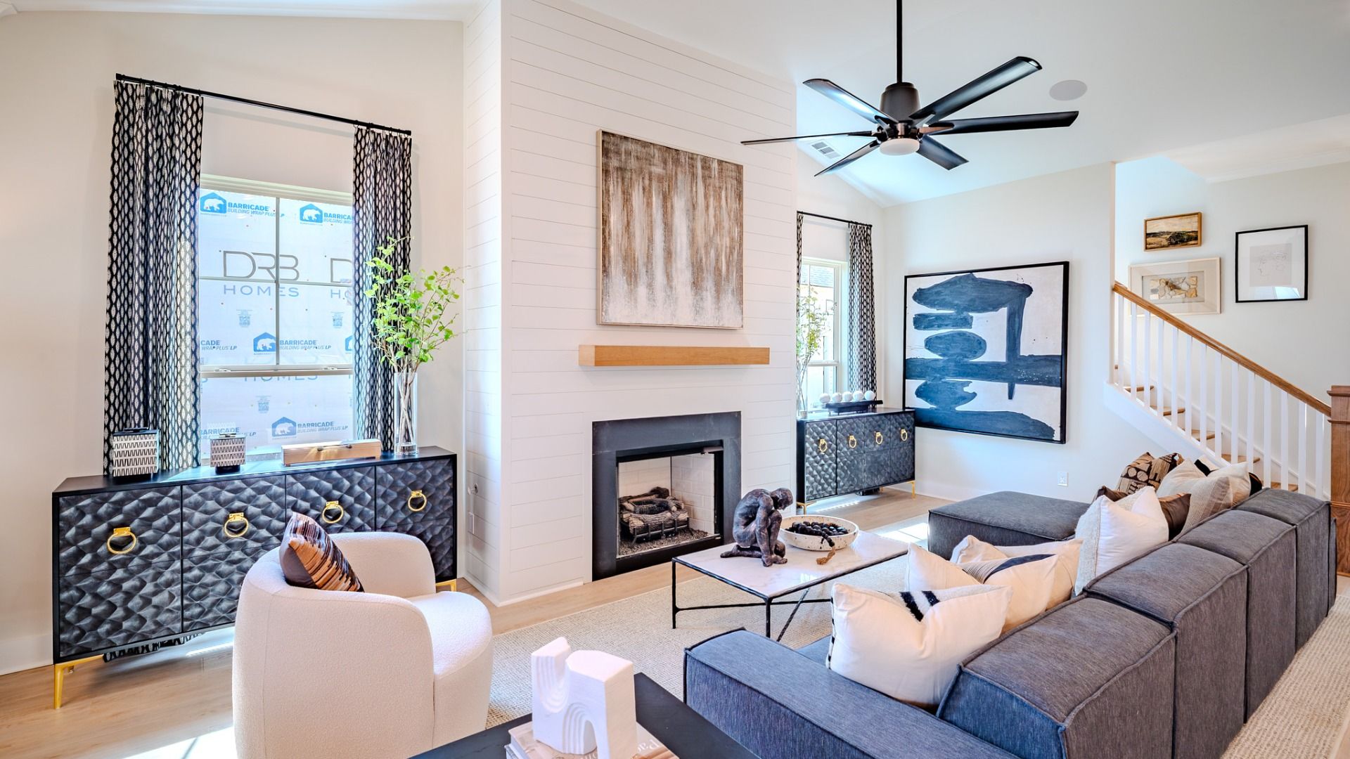 Gathering room with fireplace, ceiling fan, large windows