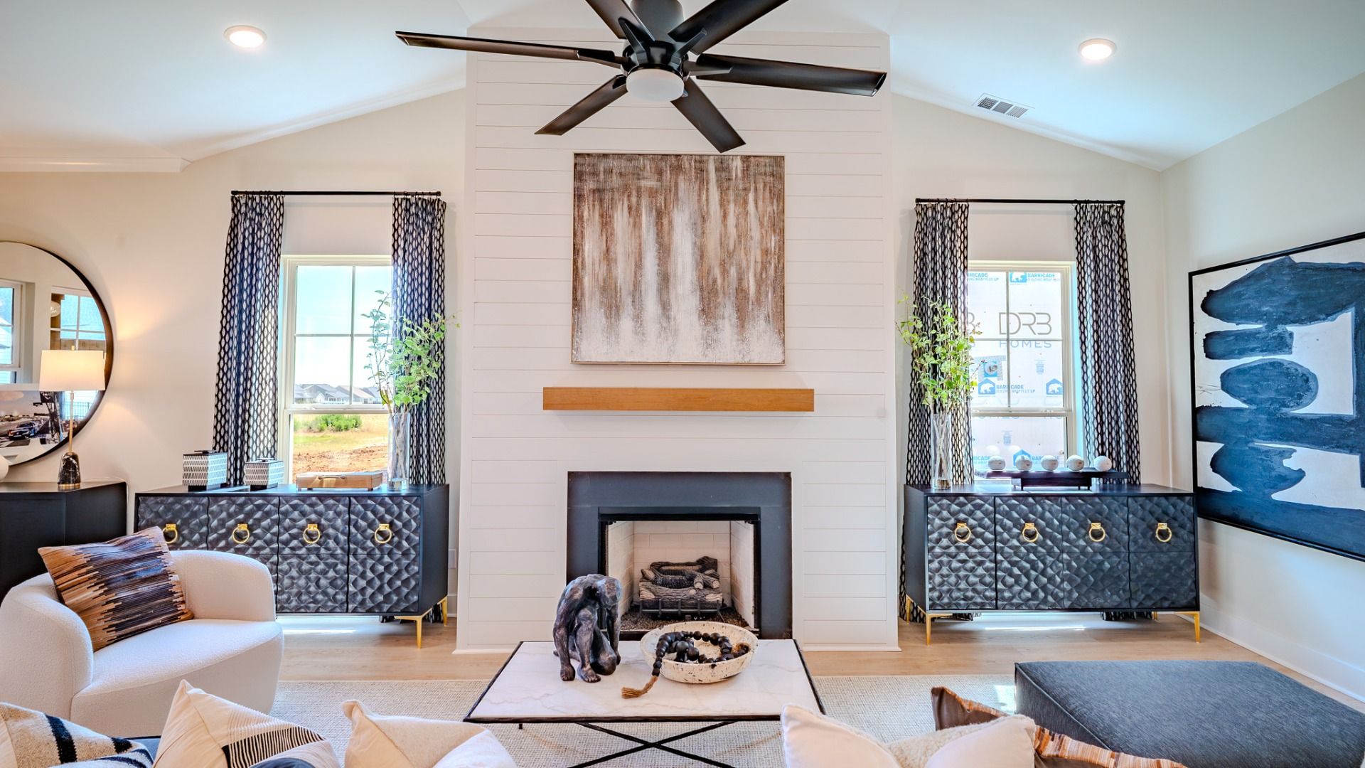 Gathering room with fireplace, ceiling fan, large windows