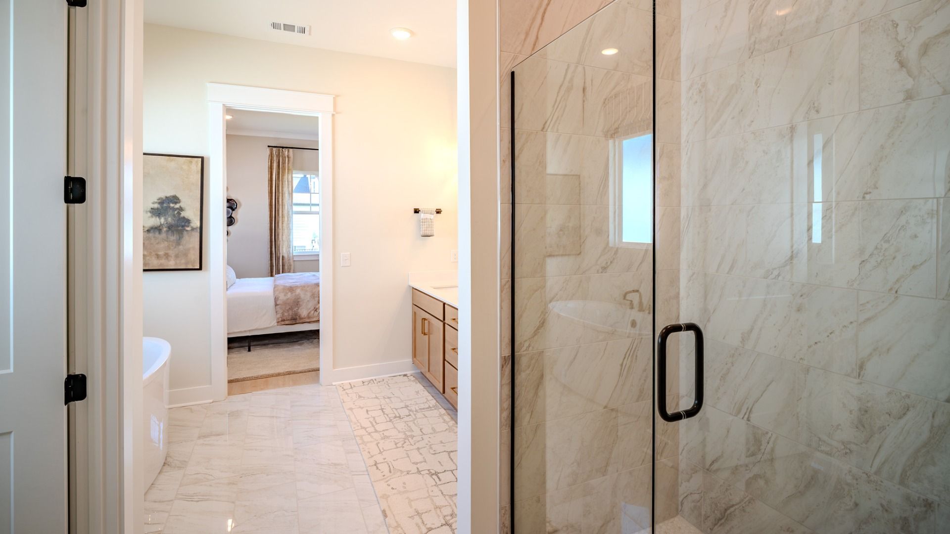 Primary bathroom with dual vanity and glass enclosed shower