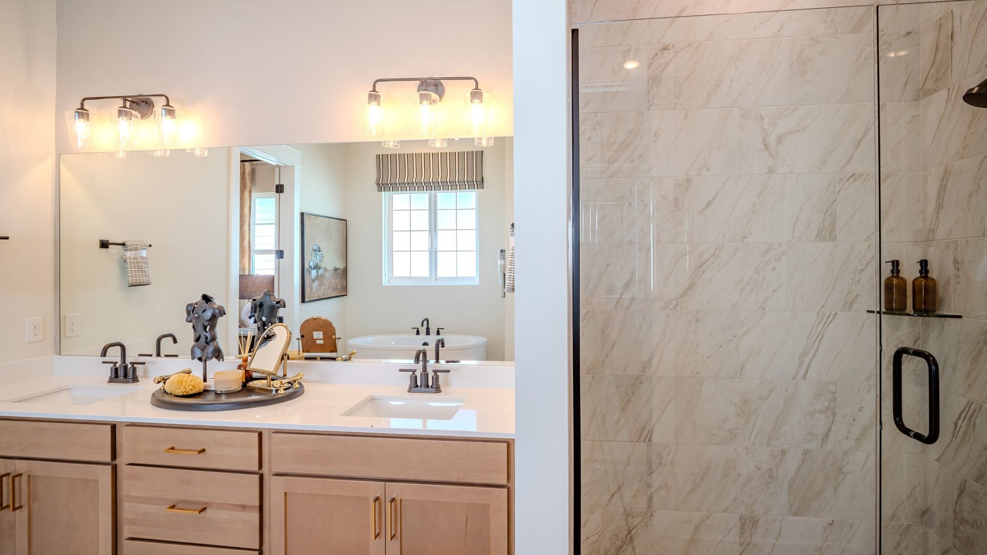 Primary bathroom with dual vanity and glass enclosed shower
