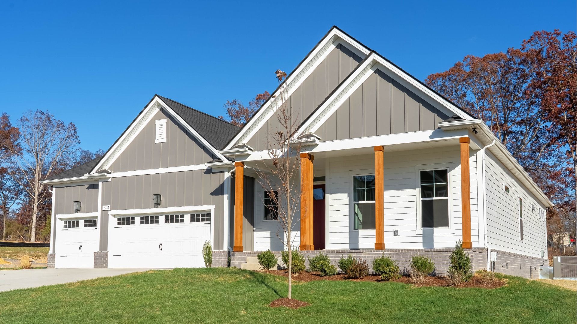 Burgess plan exterior with 3-car garage and covered front porch