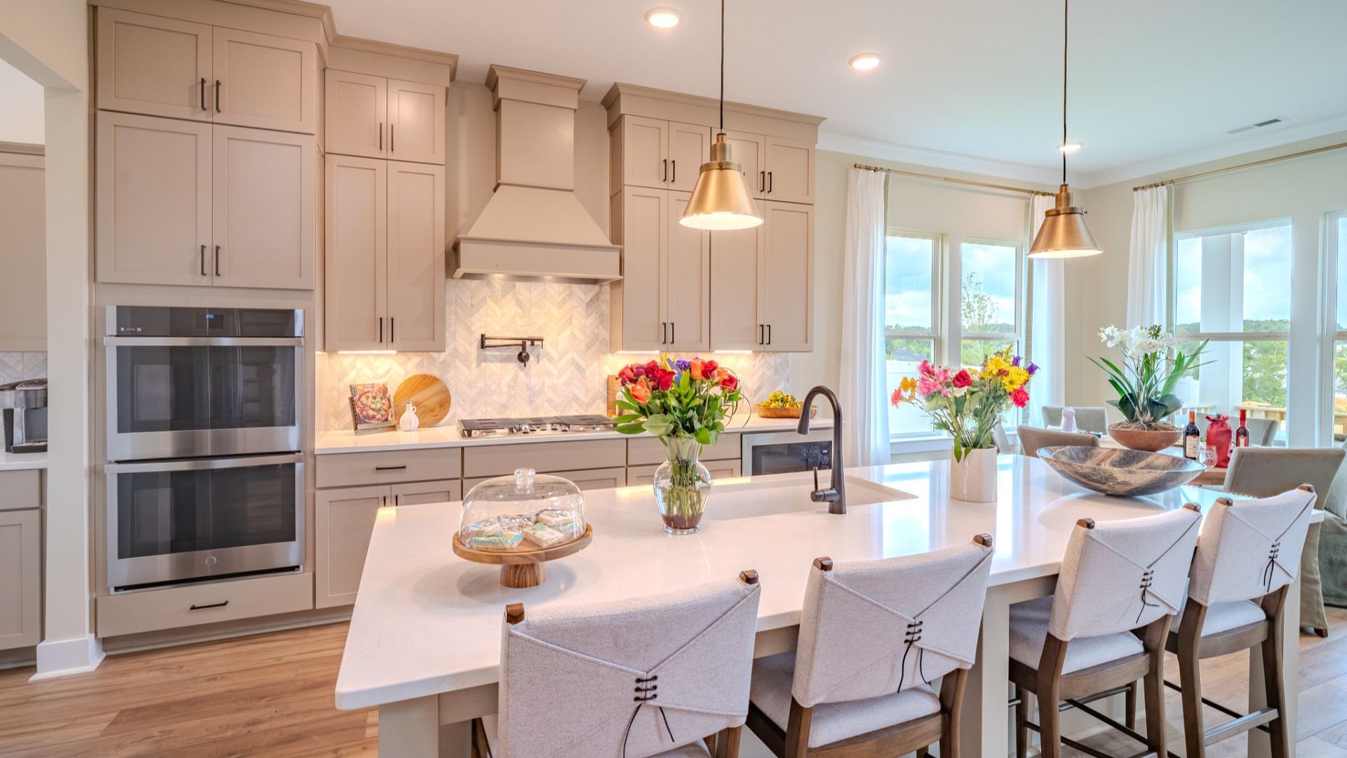 Large gourmet kitchen with standard upgraded appliances, quartz countertops, and ceramic tile backsplash