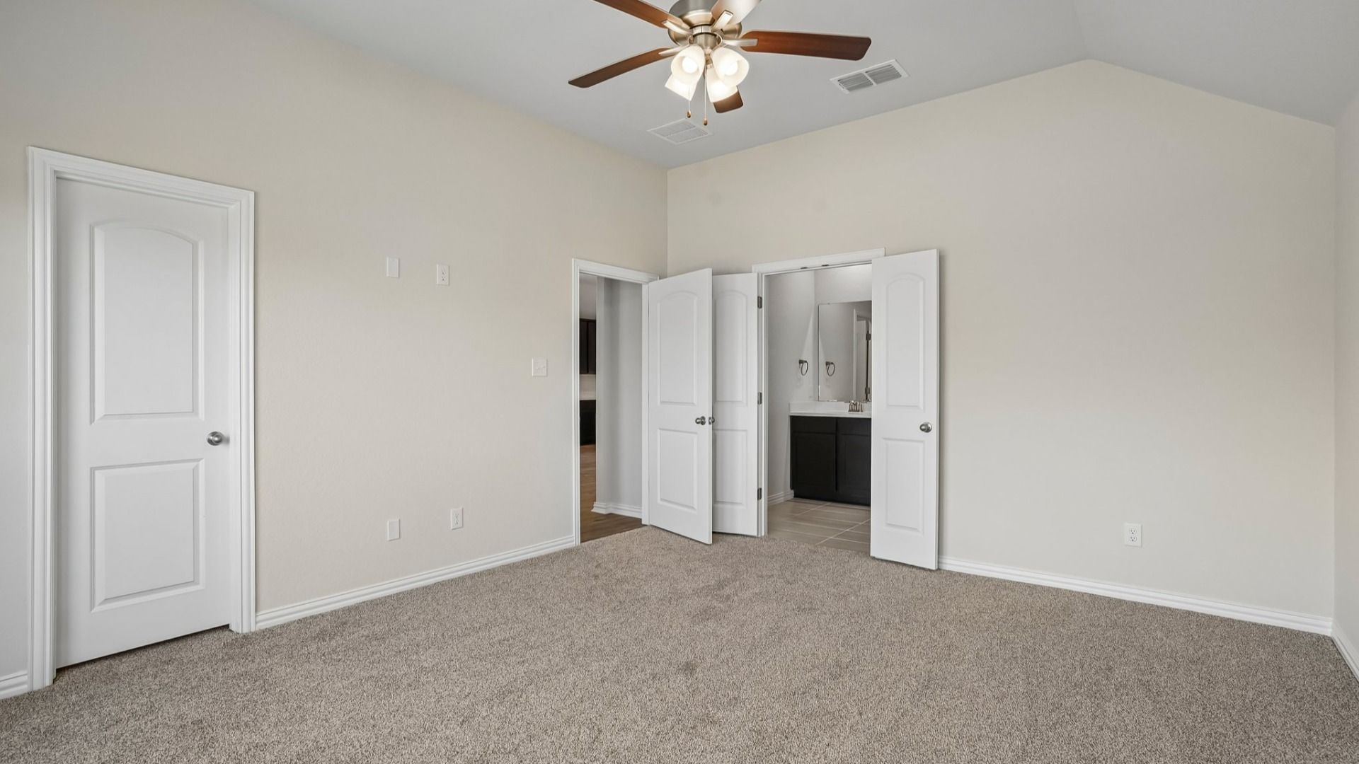 Owner's suite with abundant natural light and peaceful backyard views for a bright, relaxing retreat.
