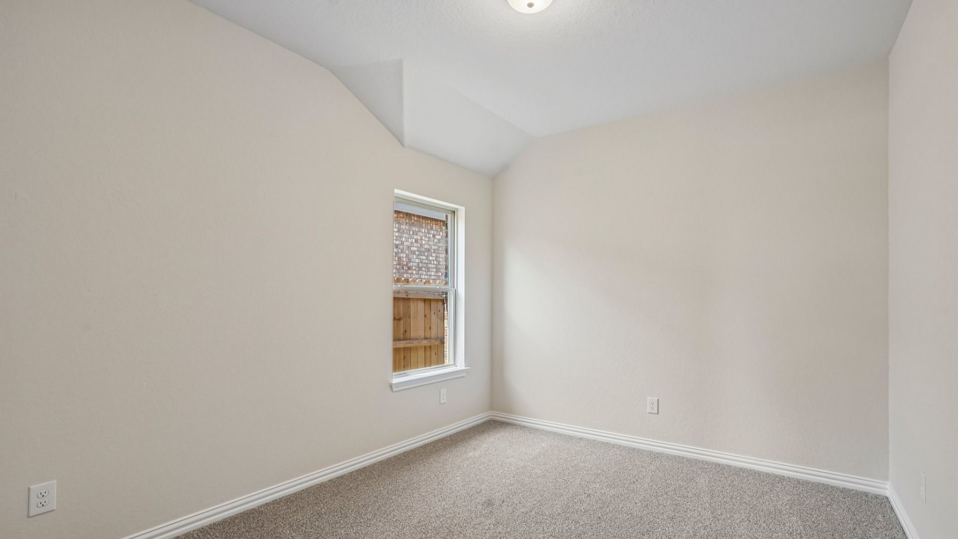 Comfortable secondary bedroom with abundant natural light and versatile space for household members, guests, or study.