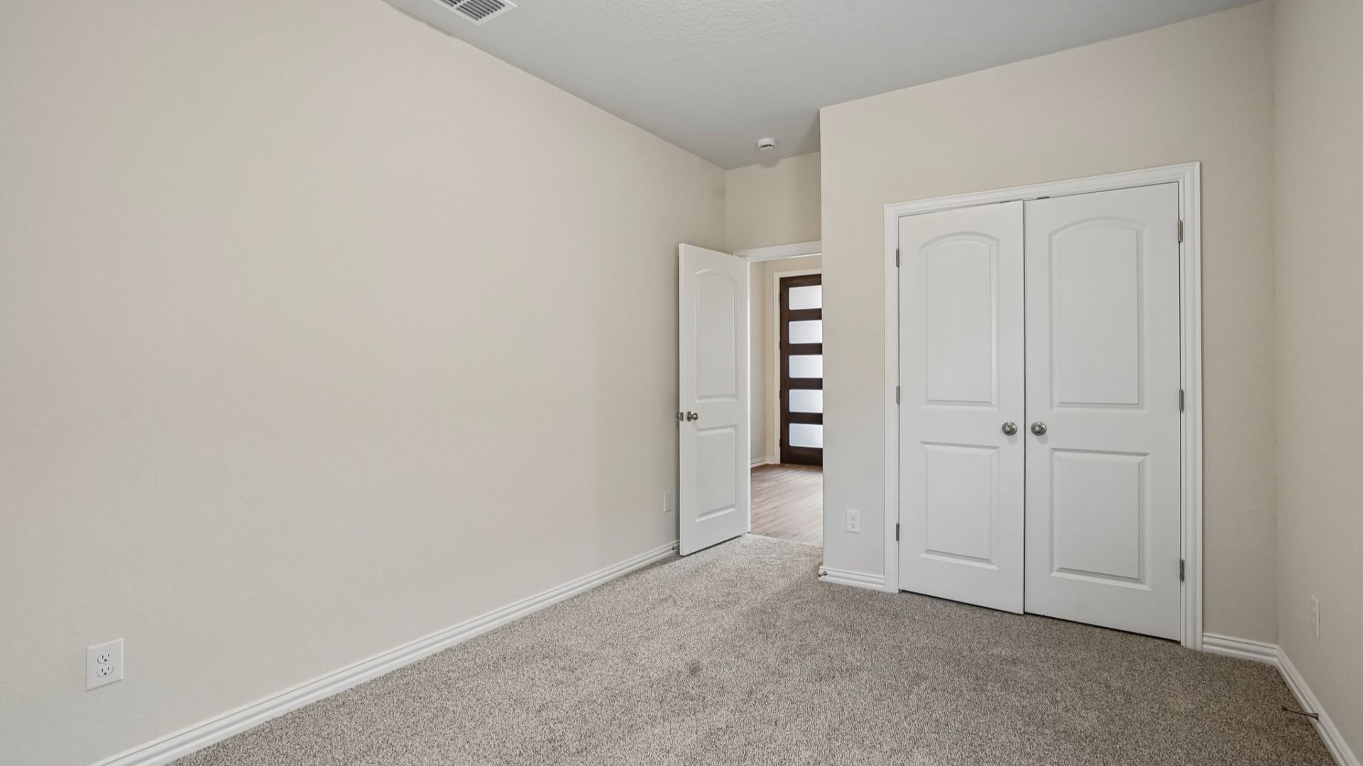 Comfortable secondary bedroom with abundant natural light and versatile space for household members, guests, or study.