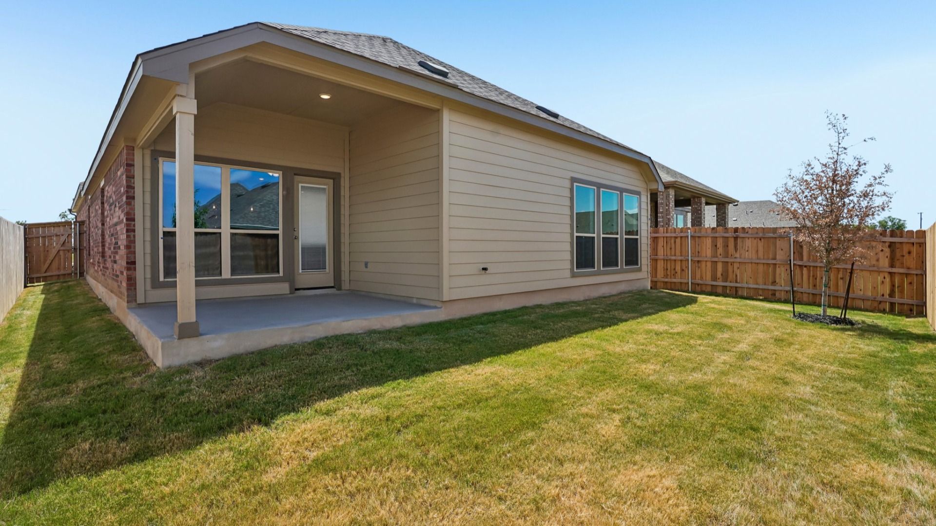 Covered patio overlooking the backyard, creating a comfortable outdoor space for relaxing and entertaining.