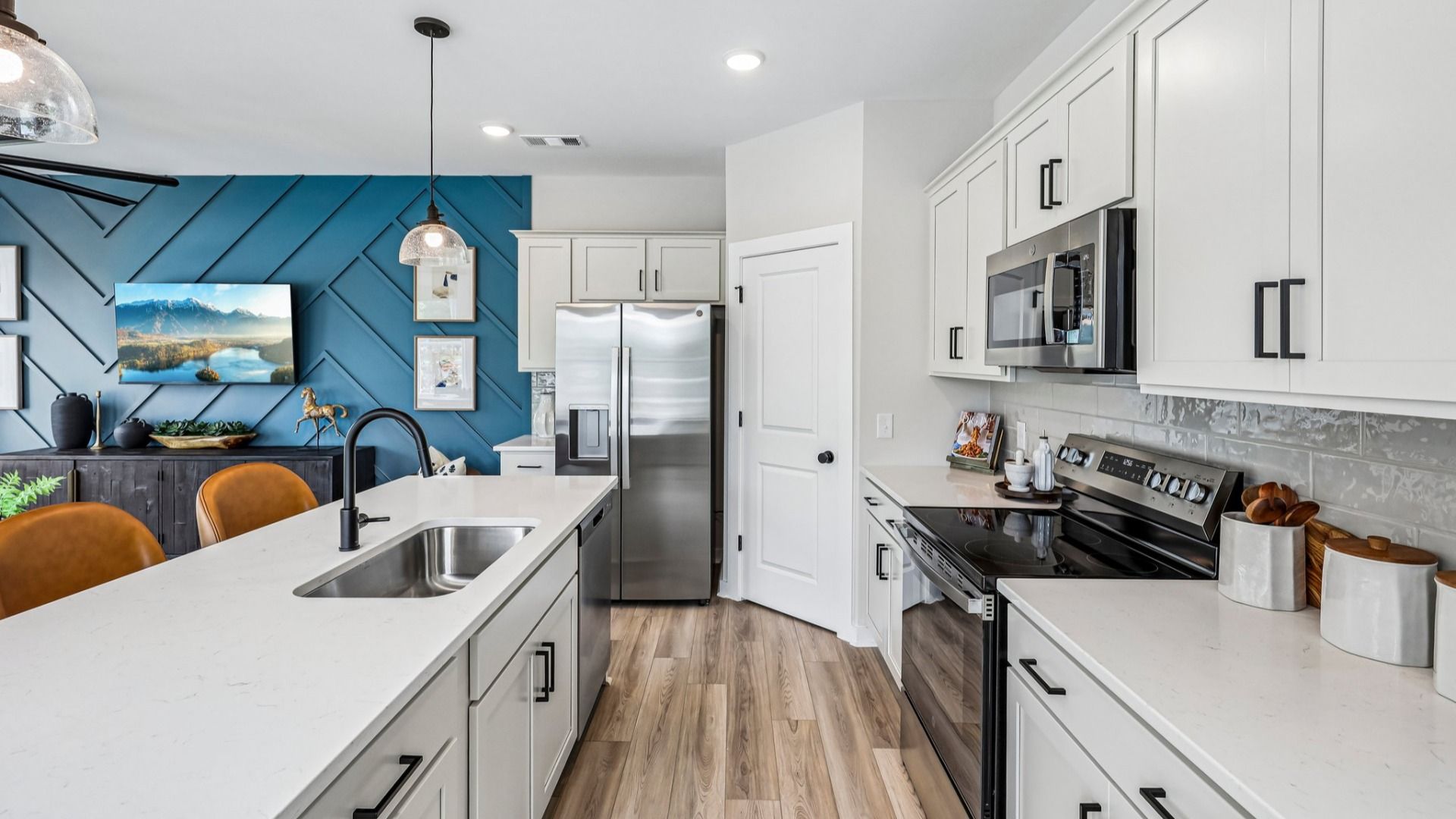View of kitchen with quartz countertops, tile backsplash, and pendant lighting