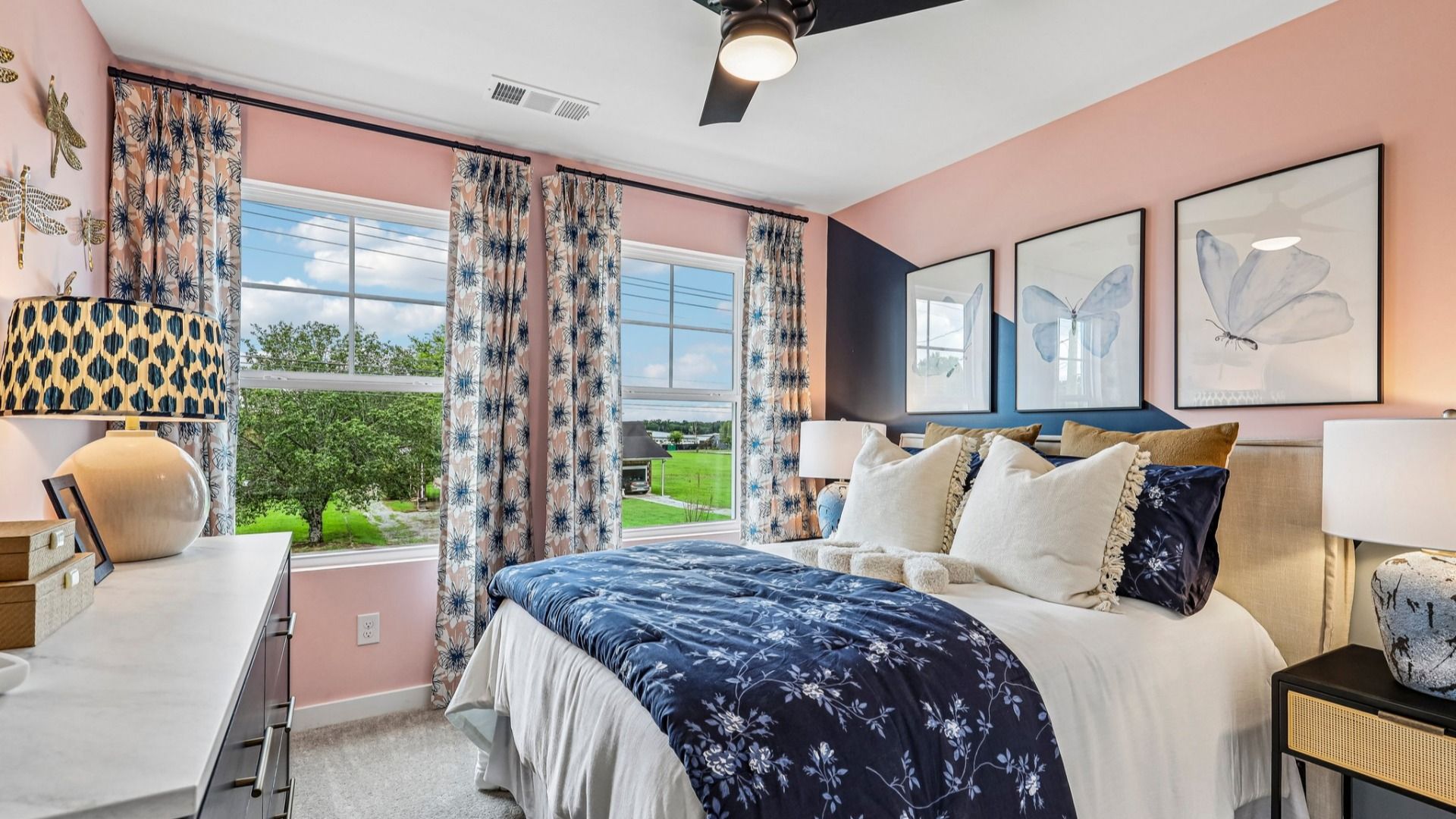 Secondary bedroom with carpet and windows
