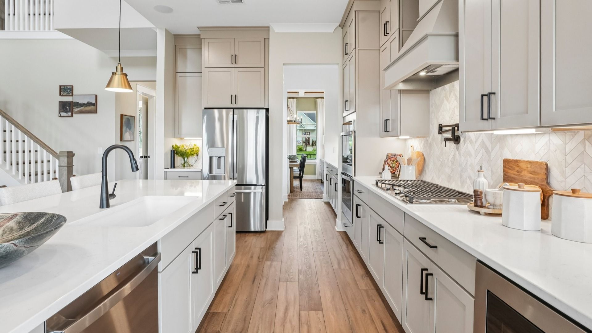 Kitchen with quartz countertops, tile backsplash, and pendant lighting