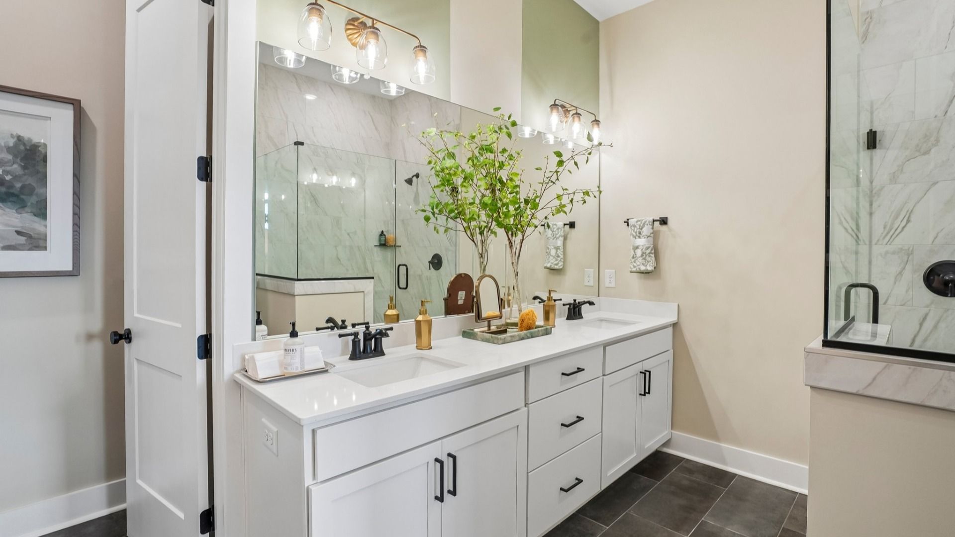 Primary bathroom with dual vanity and glass enclosed shower
