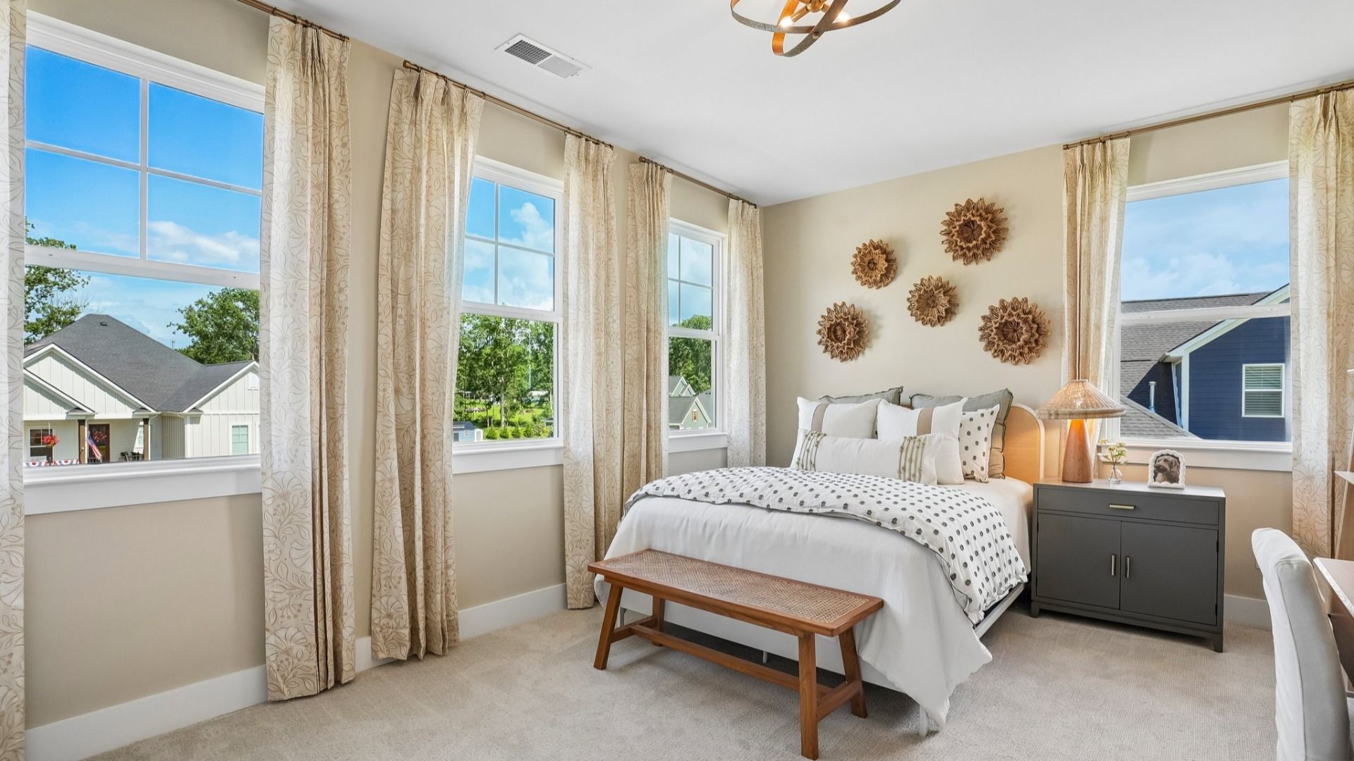 Secondary bedroom with natural lighting from windows and carpet