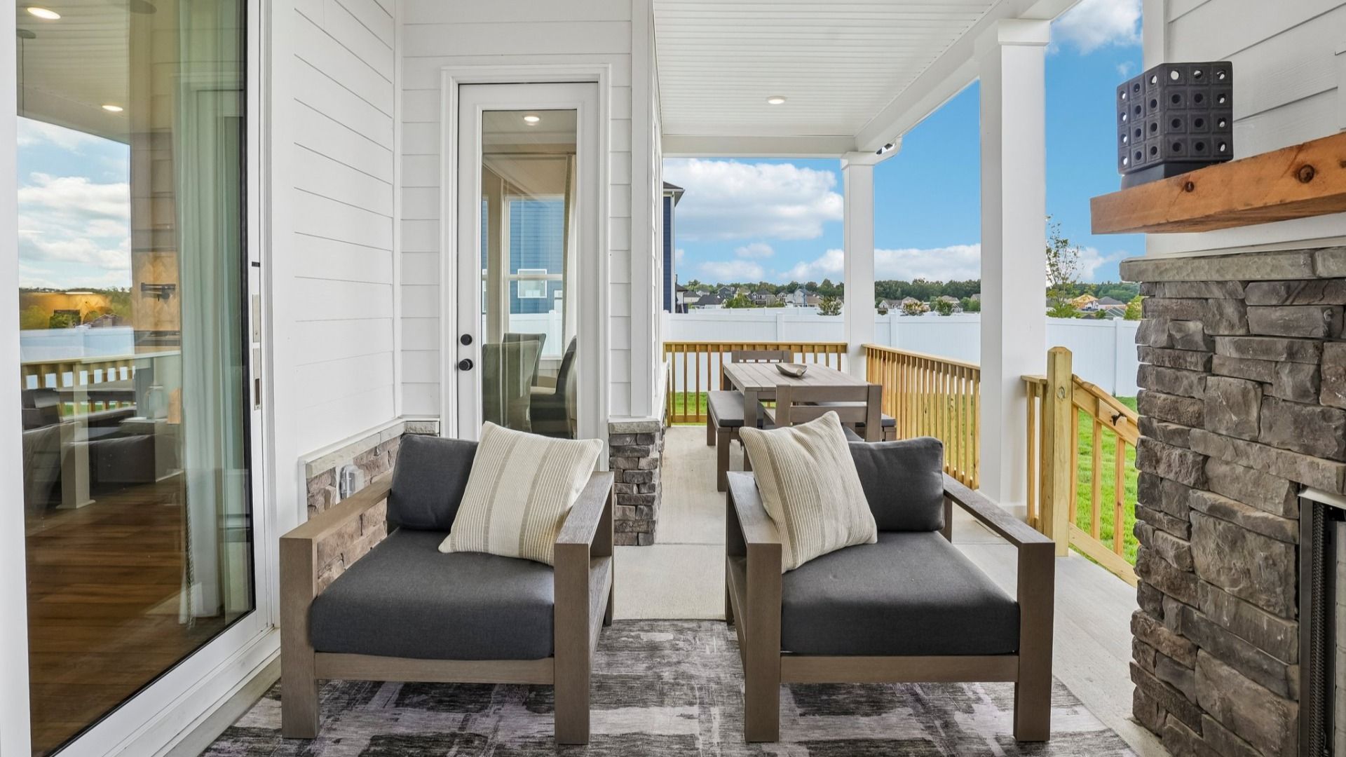 Spacious rear covered patio with access to rear entry of home