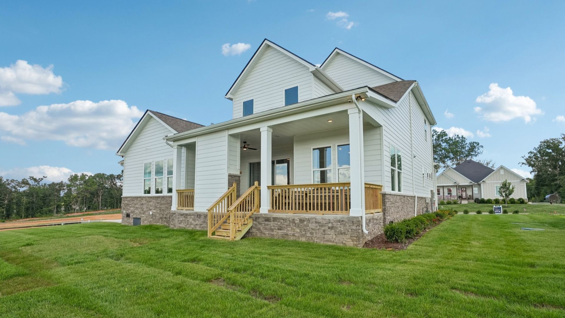 Rear exterior with view of large, covered porch