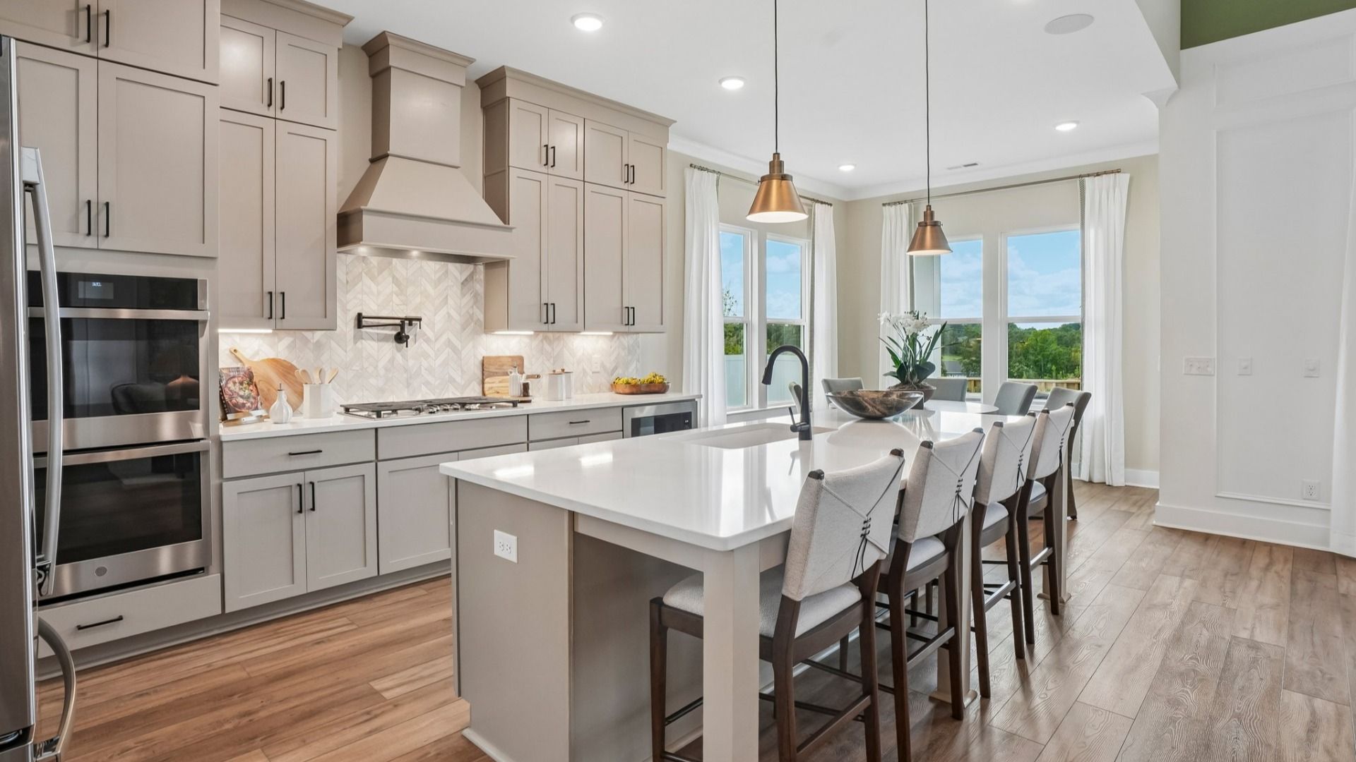 View of kitchen with quartz countertops, tile backsplash, and pendant lighting