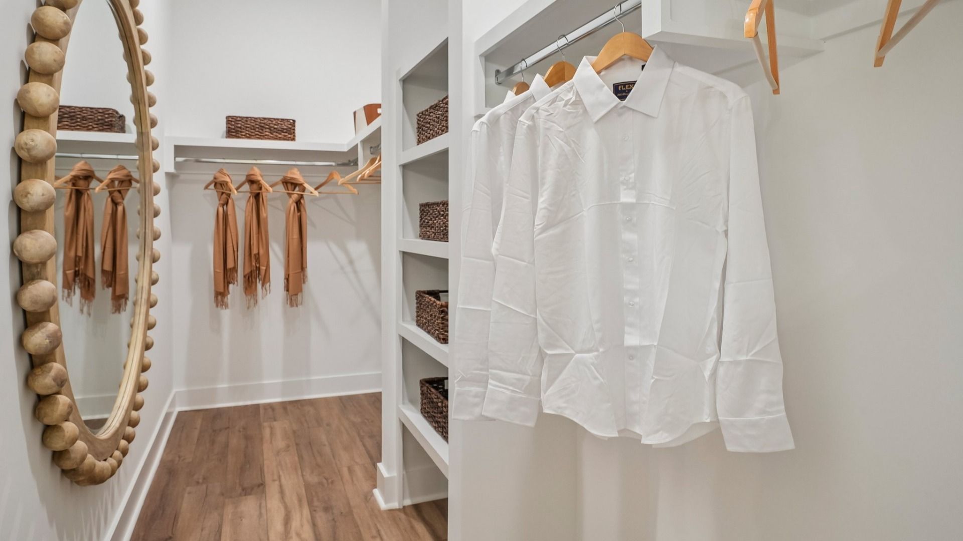 Primary closet with built-in shelves and hard surface flooring