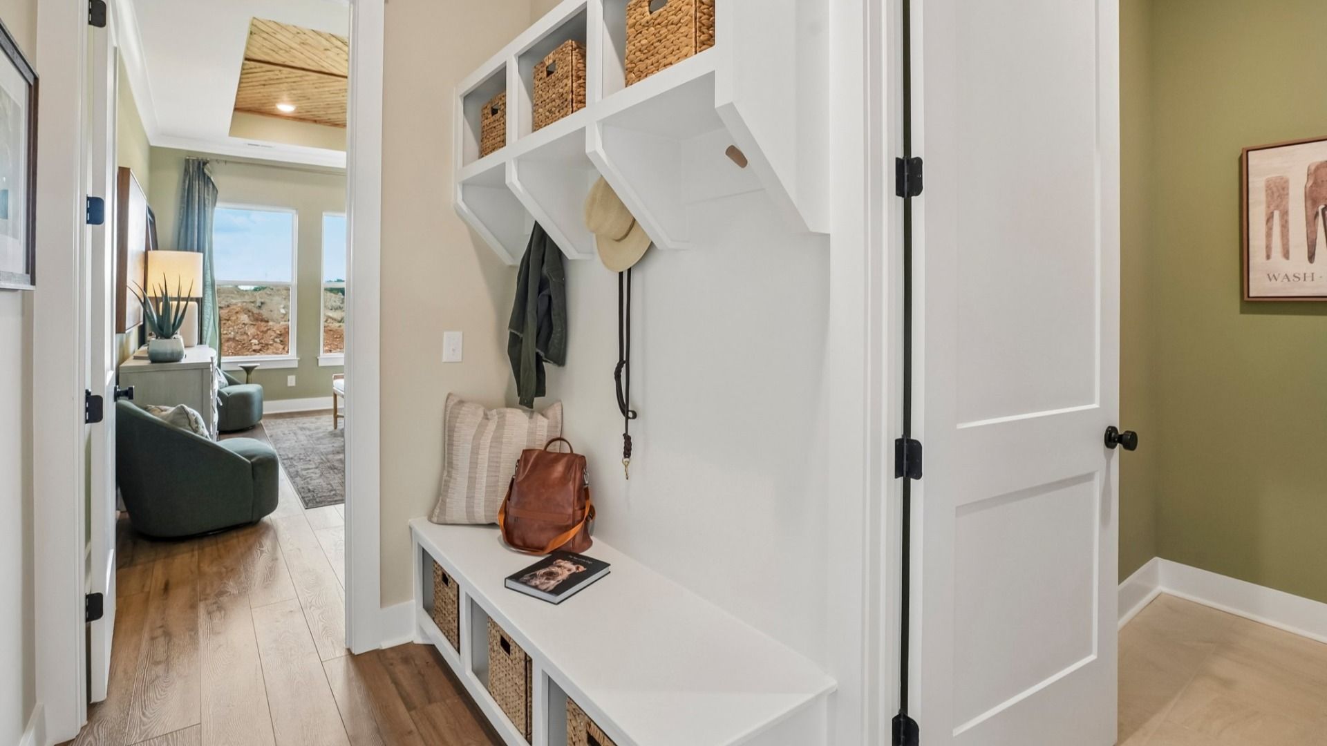 Dedicated drop-zone with access to primary suite and dedicated laundry room