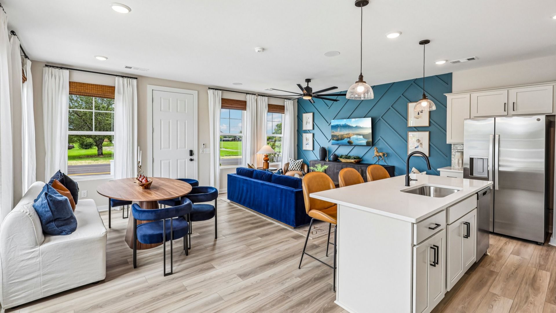 First floor view of gathering room, dining area, and kitchen