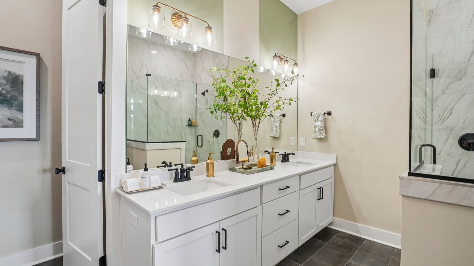 Primary bathroom with dual vanity and glass enclosed shower