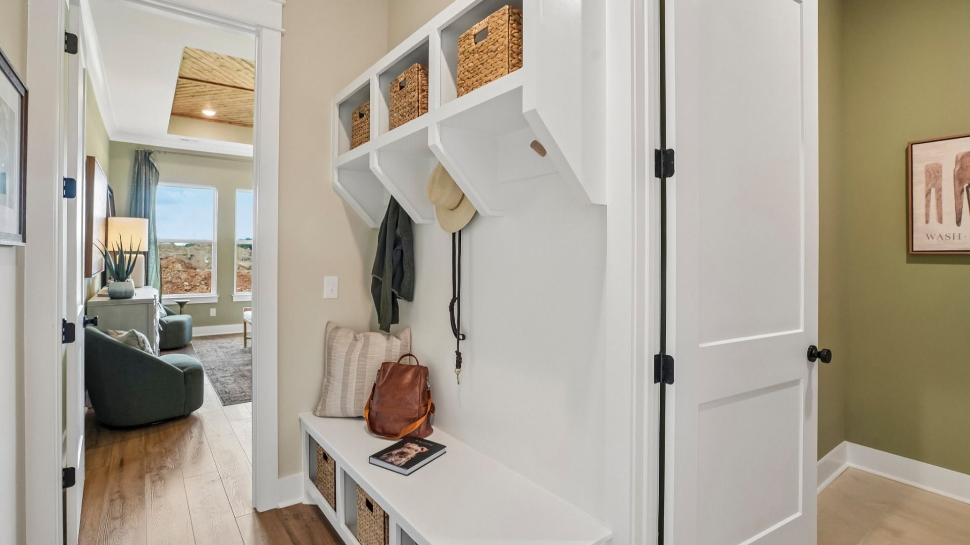 Dedicated drop-zone with access to laundry room and primary suite