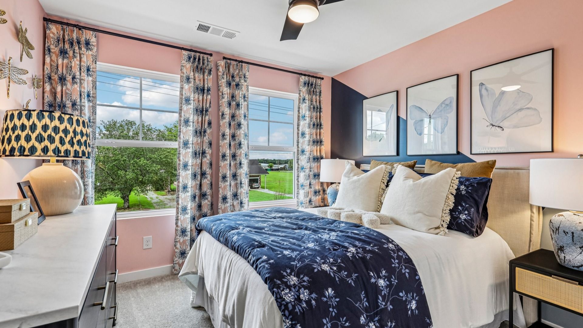 Secondary bedroom with ceiling fan, carpet, and windows