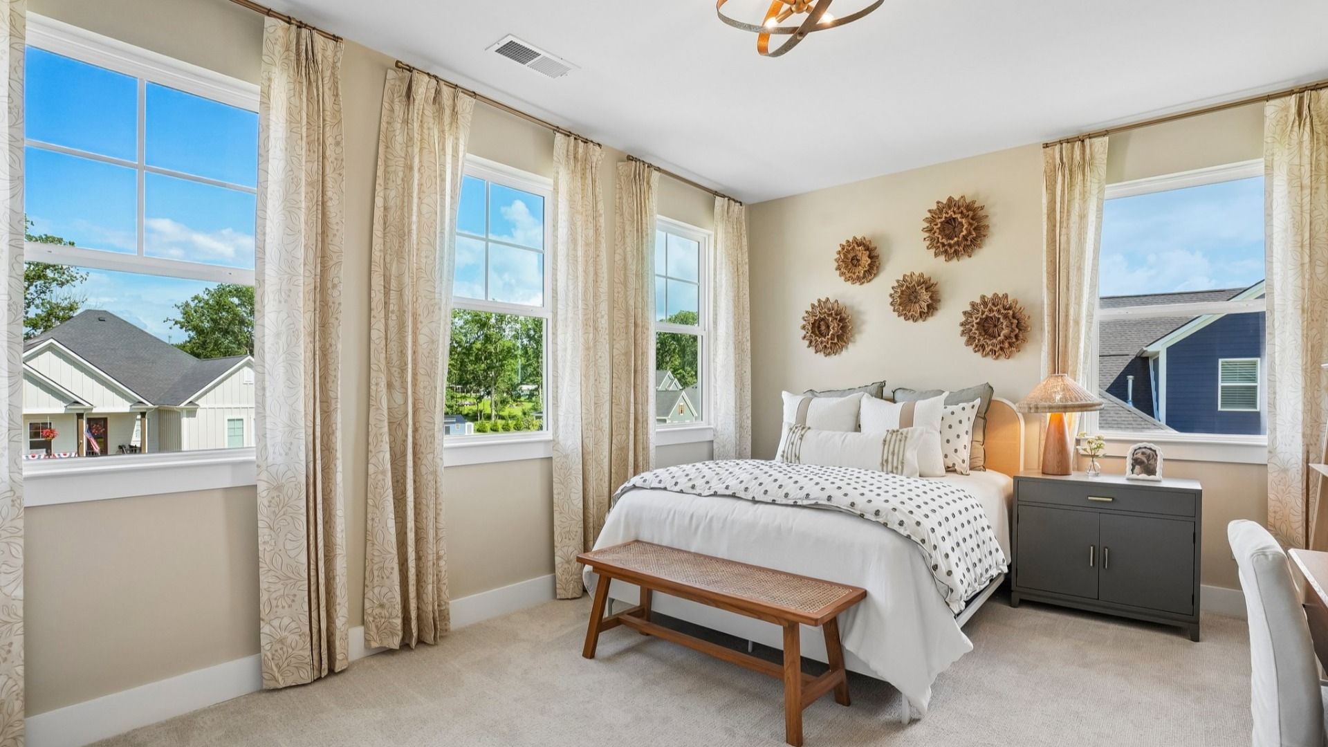 Secondary bedroom with natural lighting from windows and carpet