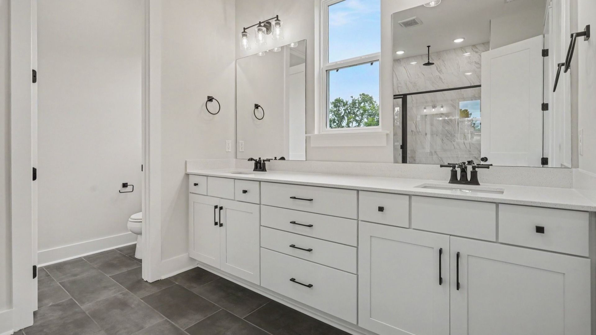 Primary bathroom with dual vanity and washroom