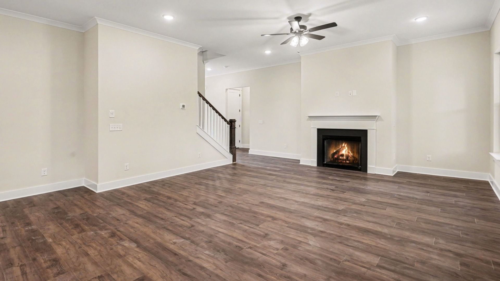 Gathering room with fireplace, ceiling fan, and hard surface flooring