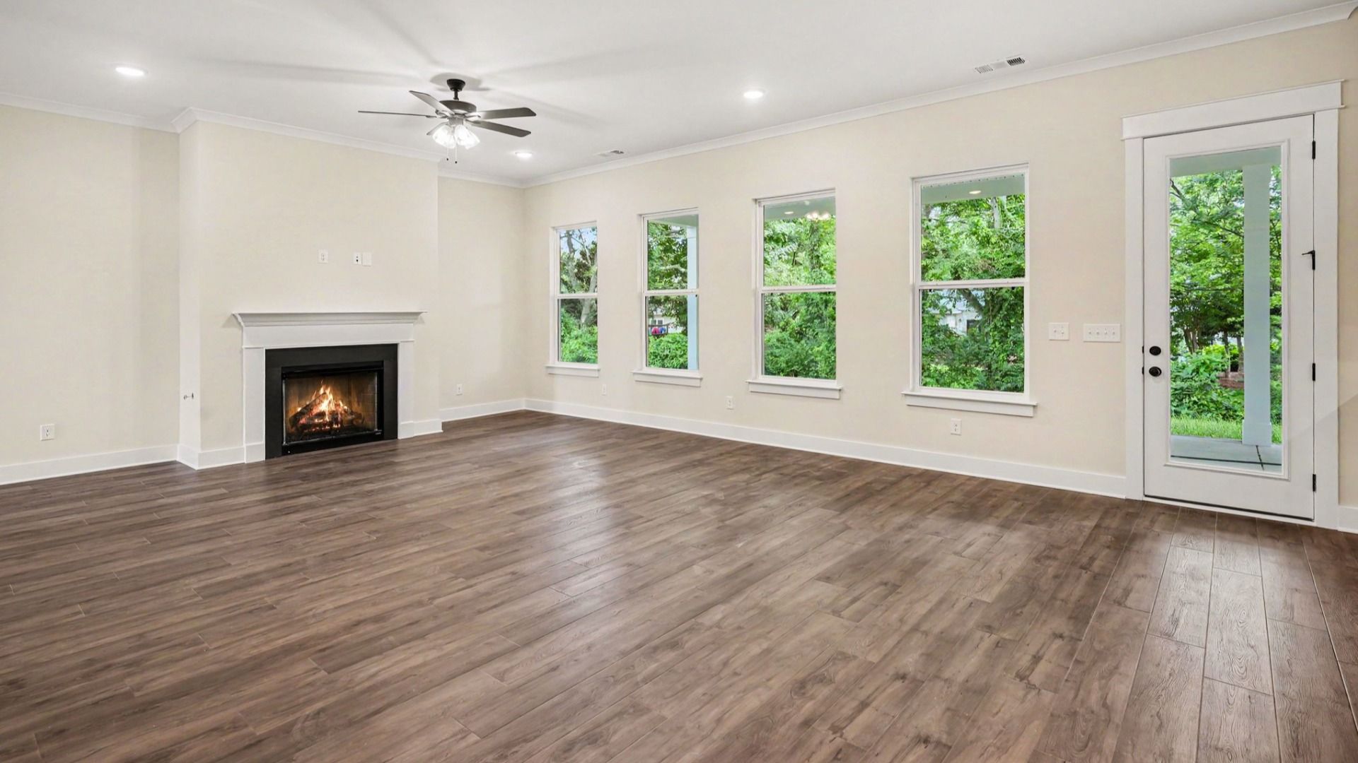 Gathering room with fireplace, ceiling fan, and hard surface flooring