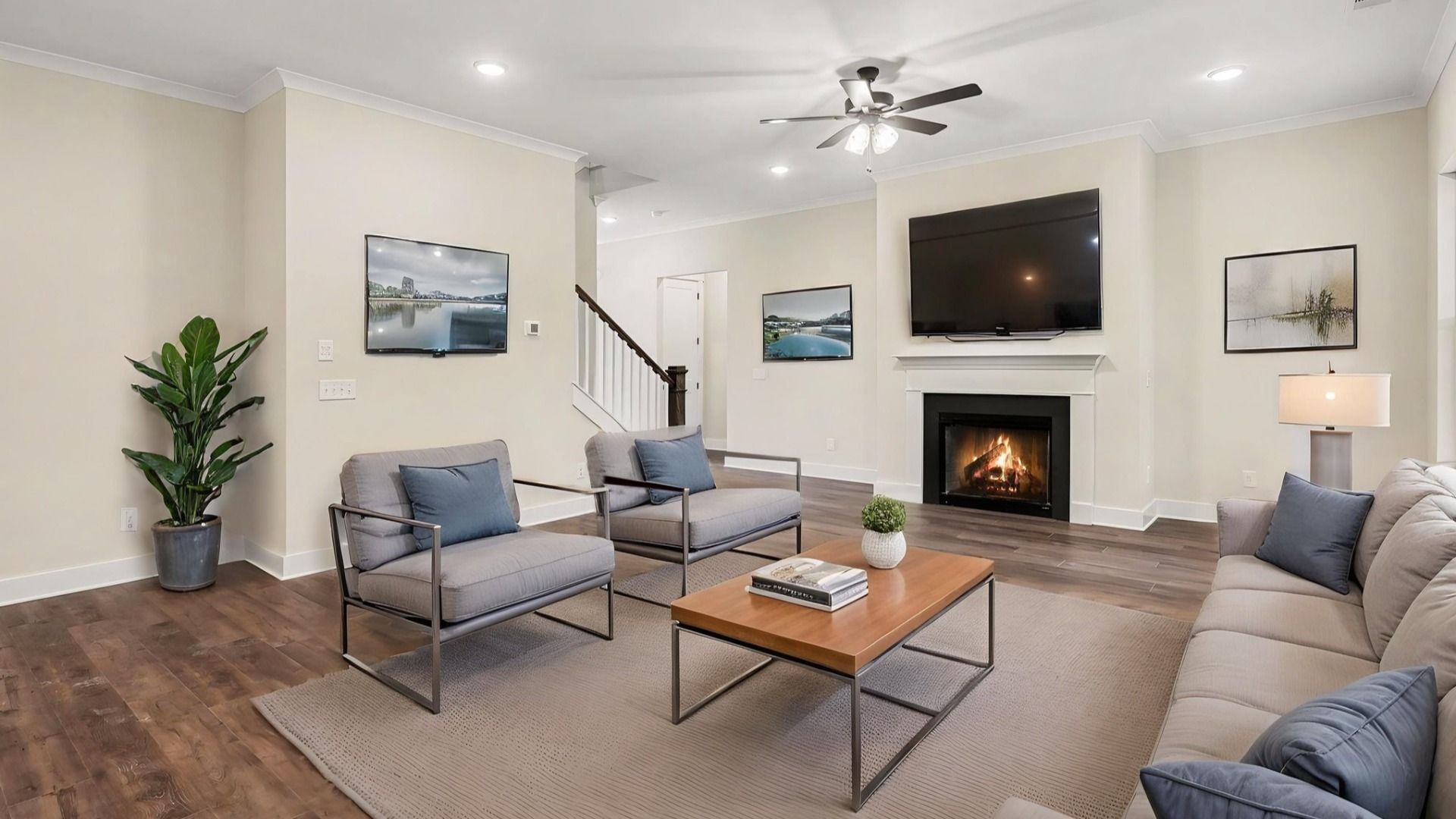 Gathering room with fireplace, ceiling fan, and hard surface flooring with furniture