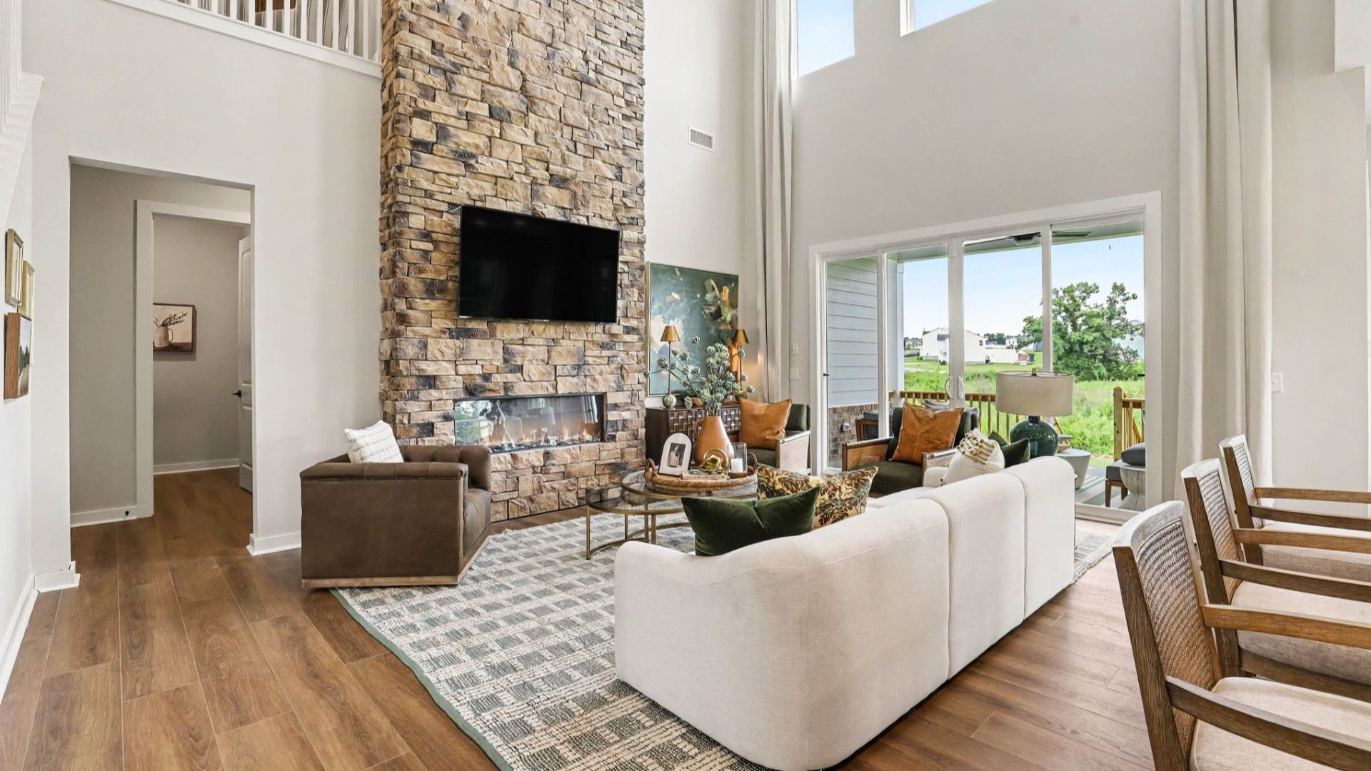 Gathering room with high ceilings and stone fireplace