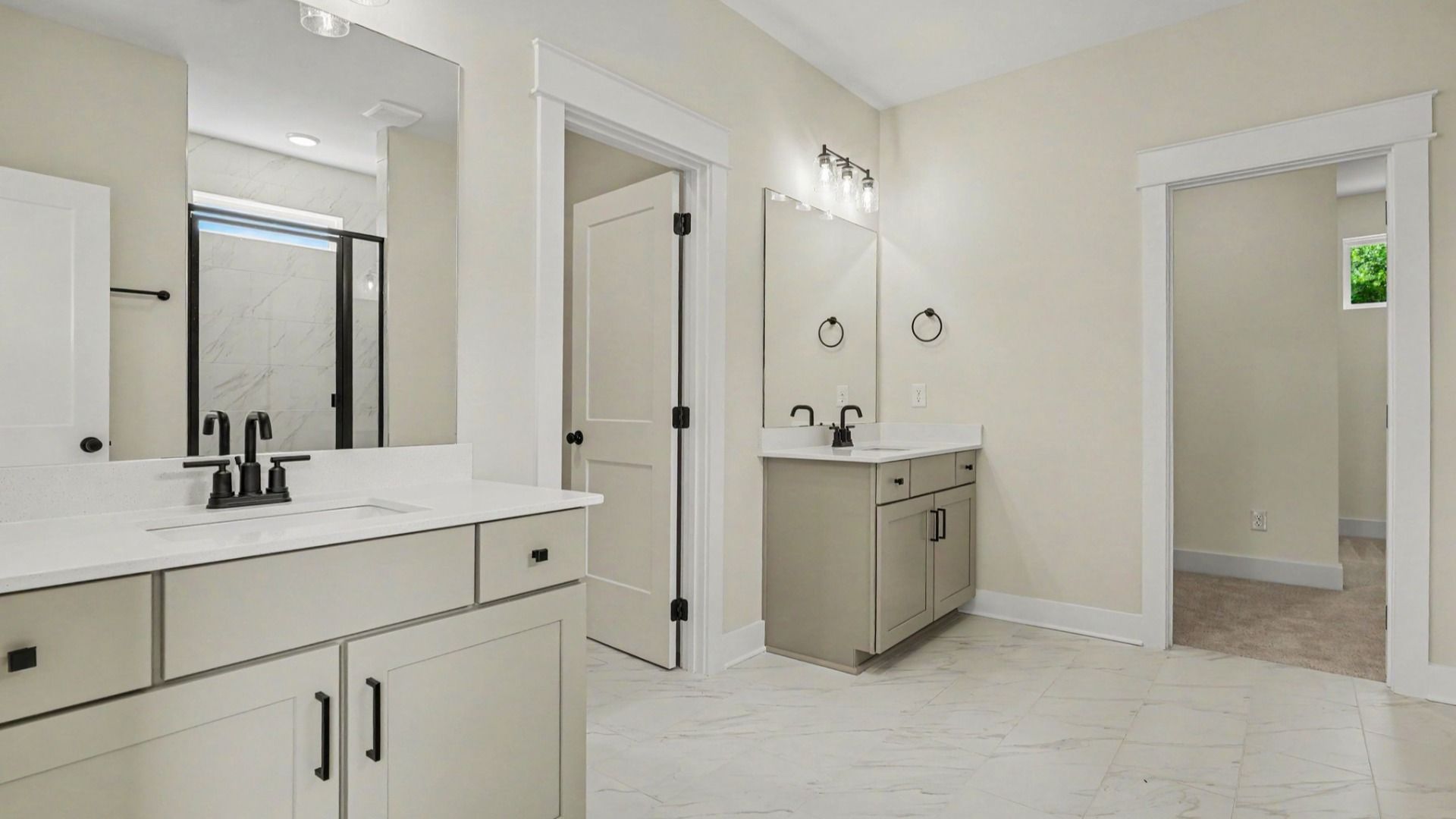 Primary bathroom with dual vanity, glass enclosed shower, and closet
