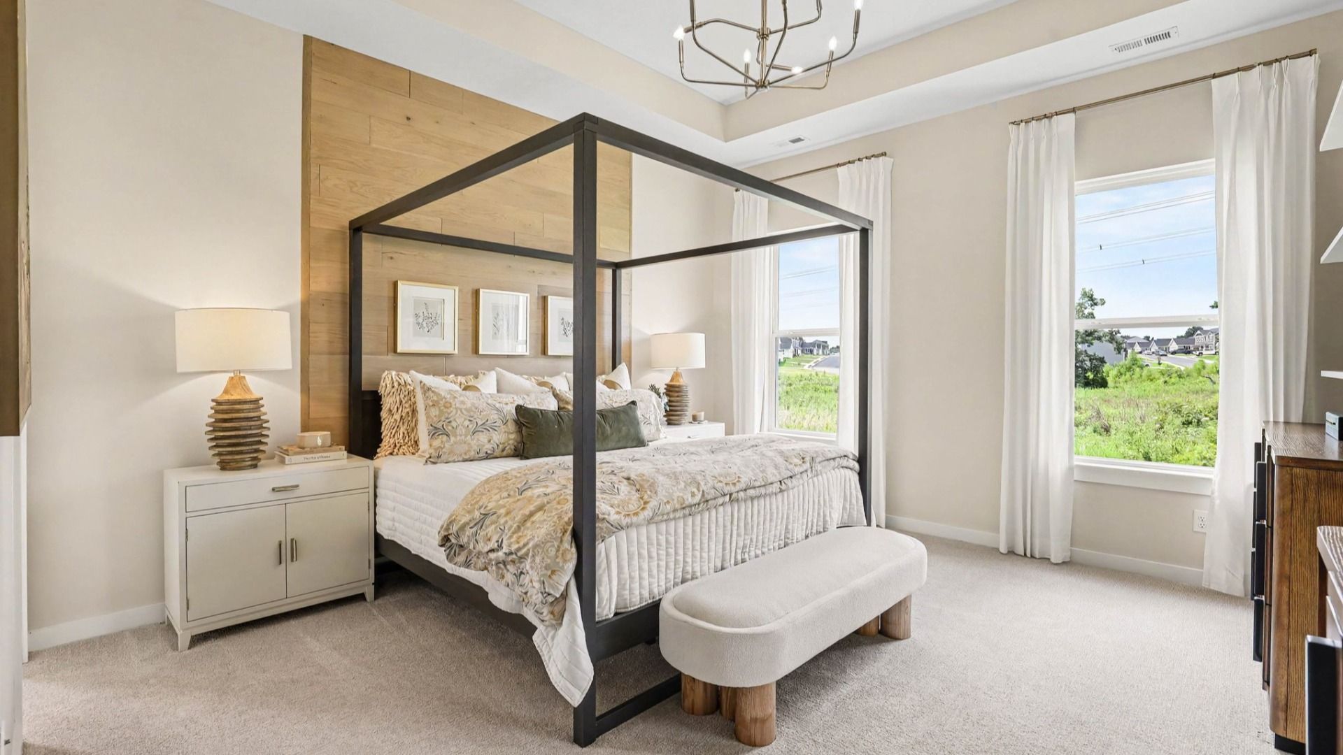 Primary suite with accent wall, carpet, and windows