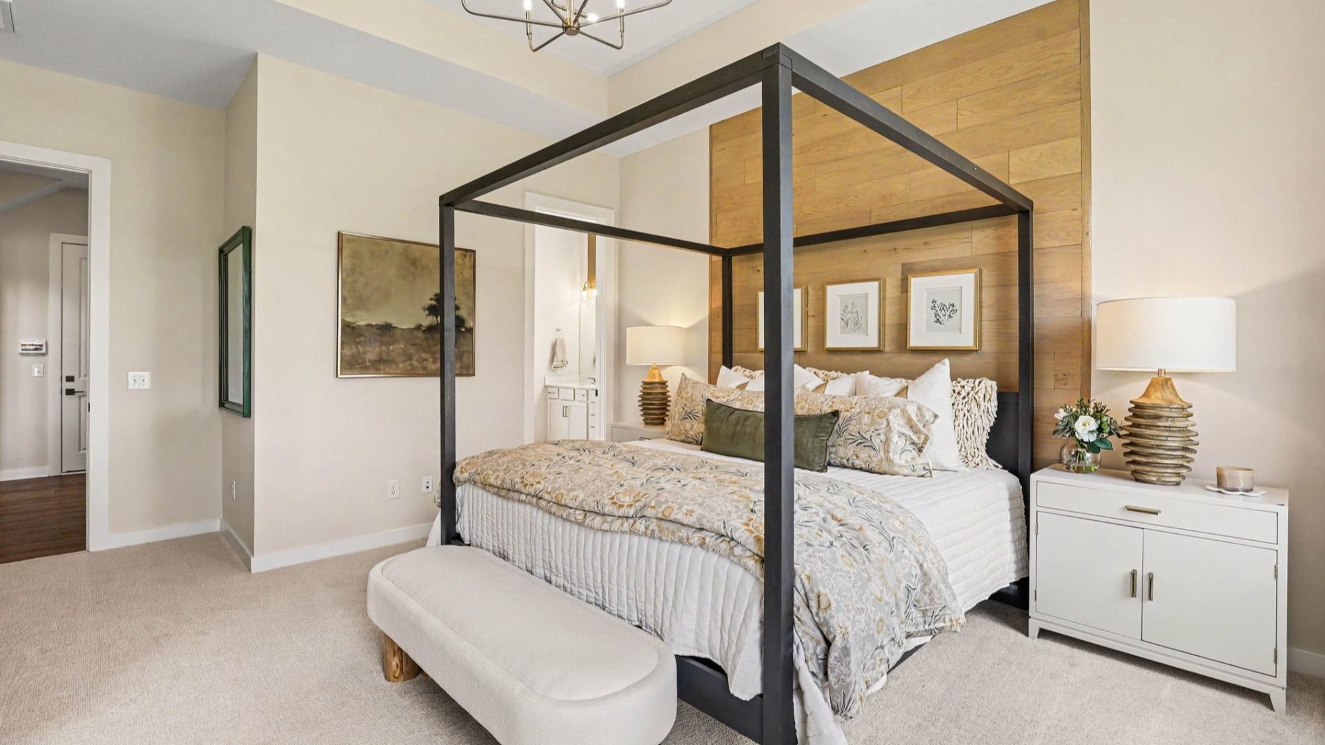 Primary suite with accent wall, carpet, and windows