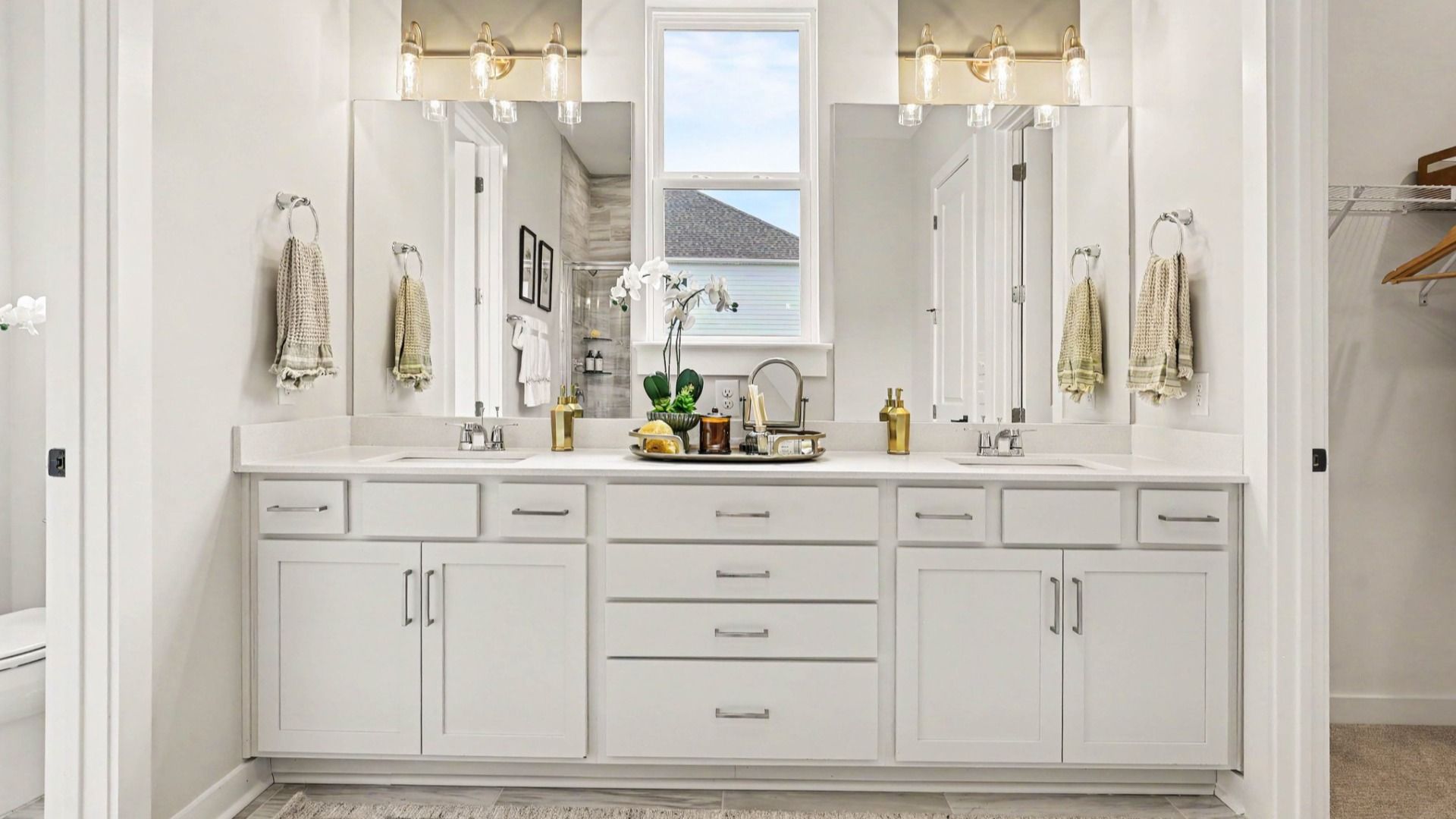 Primary bathroom with bright natural lighting and dual vanity