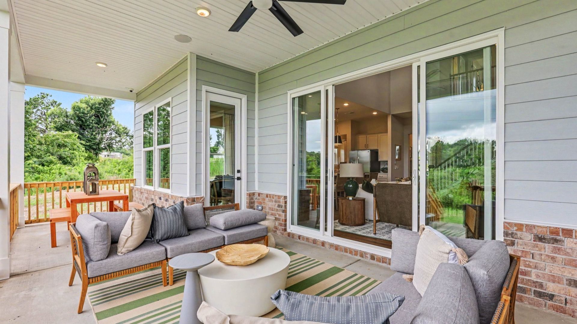 Spacious rear covered patio with ceiling fan