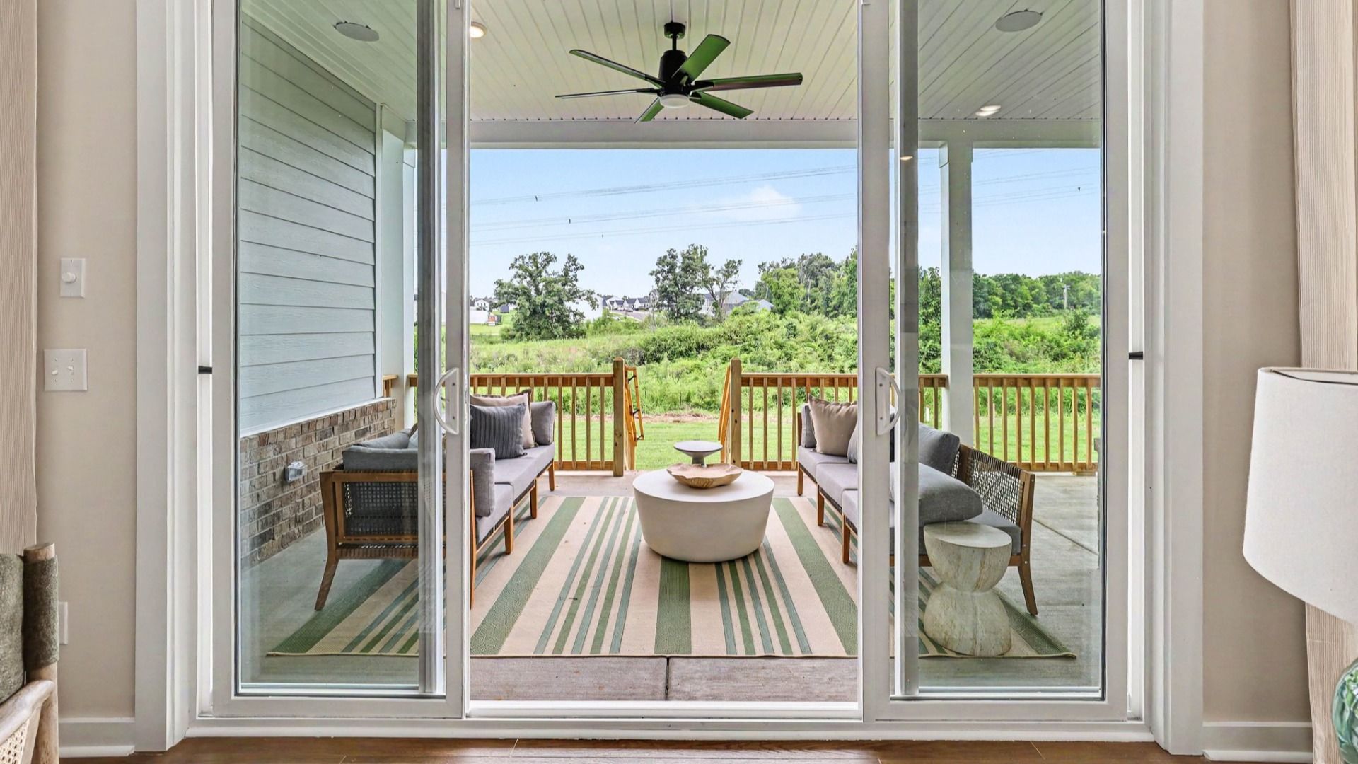 View of rear covered patio with ceiling fan