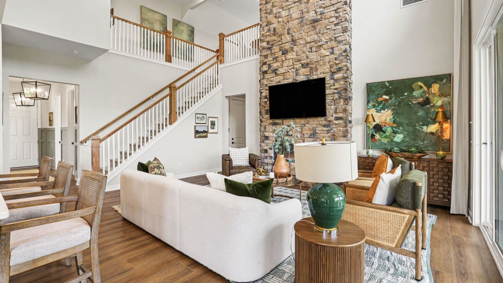 Gathering room with high ceilings and stone fireplace