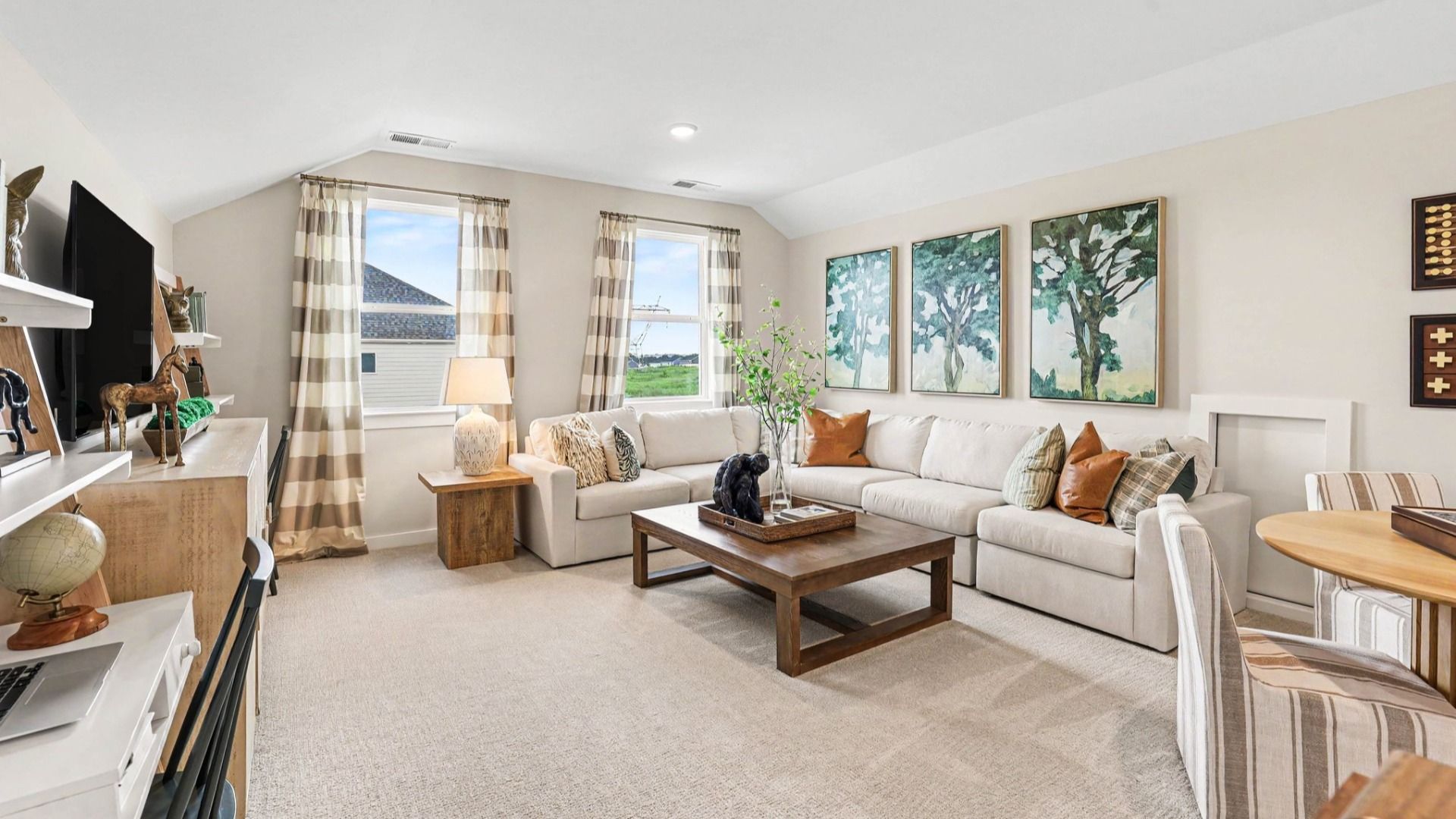 Spacious loft area with carpet and windows