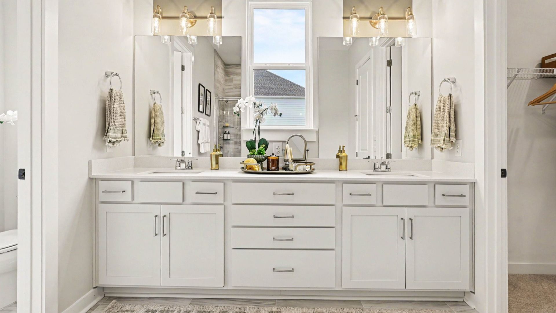 Primary bathroom with dual vanity and bright natural lighting