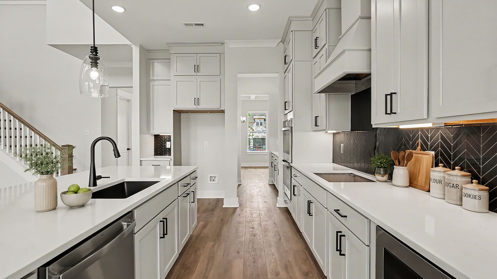 Kitchen with quartz countertops, pendant lighting, and tile backsplash
