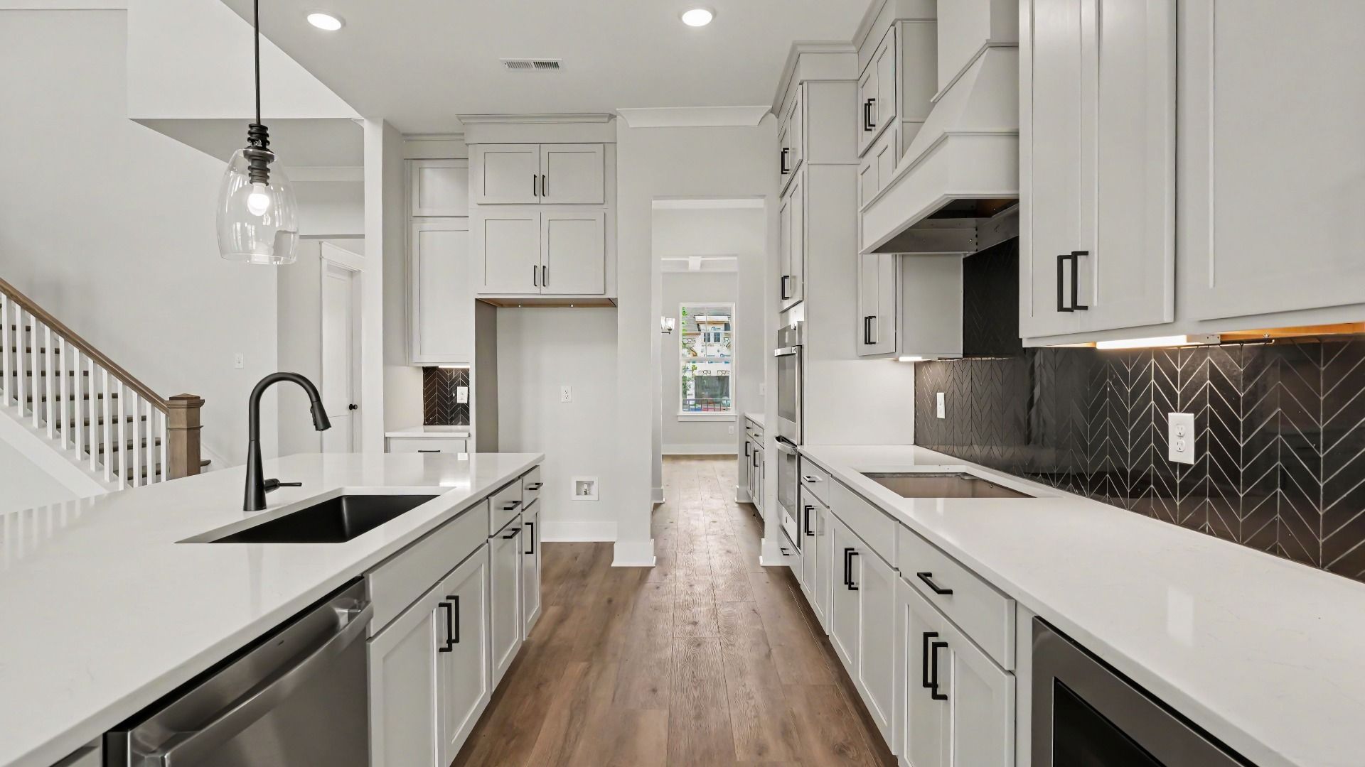 Kitchen with quartz countertops, pendant lighting, and tile backsplash